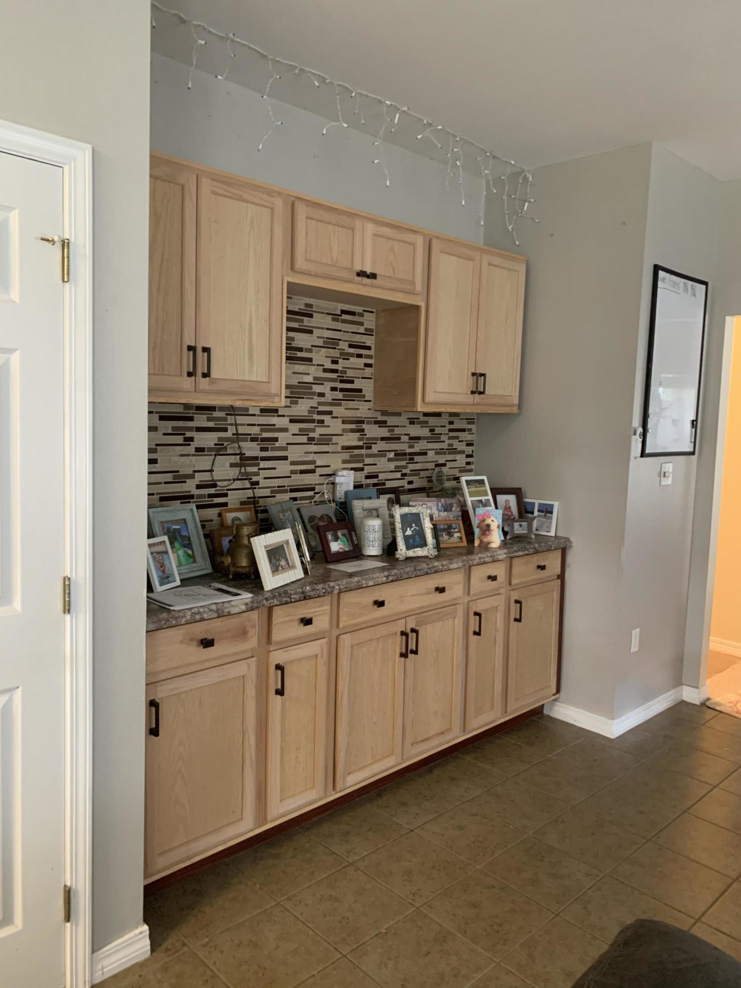 This beautiful all brick home boasts a spacious open kitchen concept, with granite countertops, and stainless steel appliances, overlooking the dining area and opening to the family room with a cozy fireplace and a massive coffee/wine bar. Wine bar has beautiful light wood cabinets, granite countertops and glass back splash. The main living area is directly off the family room. There's a large master suite with three closets, and a nook area. Master bath has double sinks, garden tub and separate toilet area. Guest bath also has a double sink vanity. Separate laundry room with extra storage cabinets. Large, privacy fenced back yard with pergola right off the kitchen/dining area. Big enough to add your own pool. Schedule your showing today!