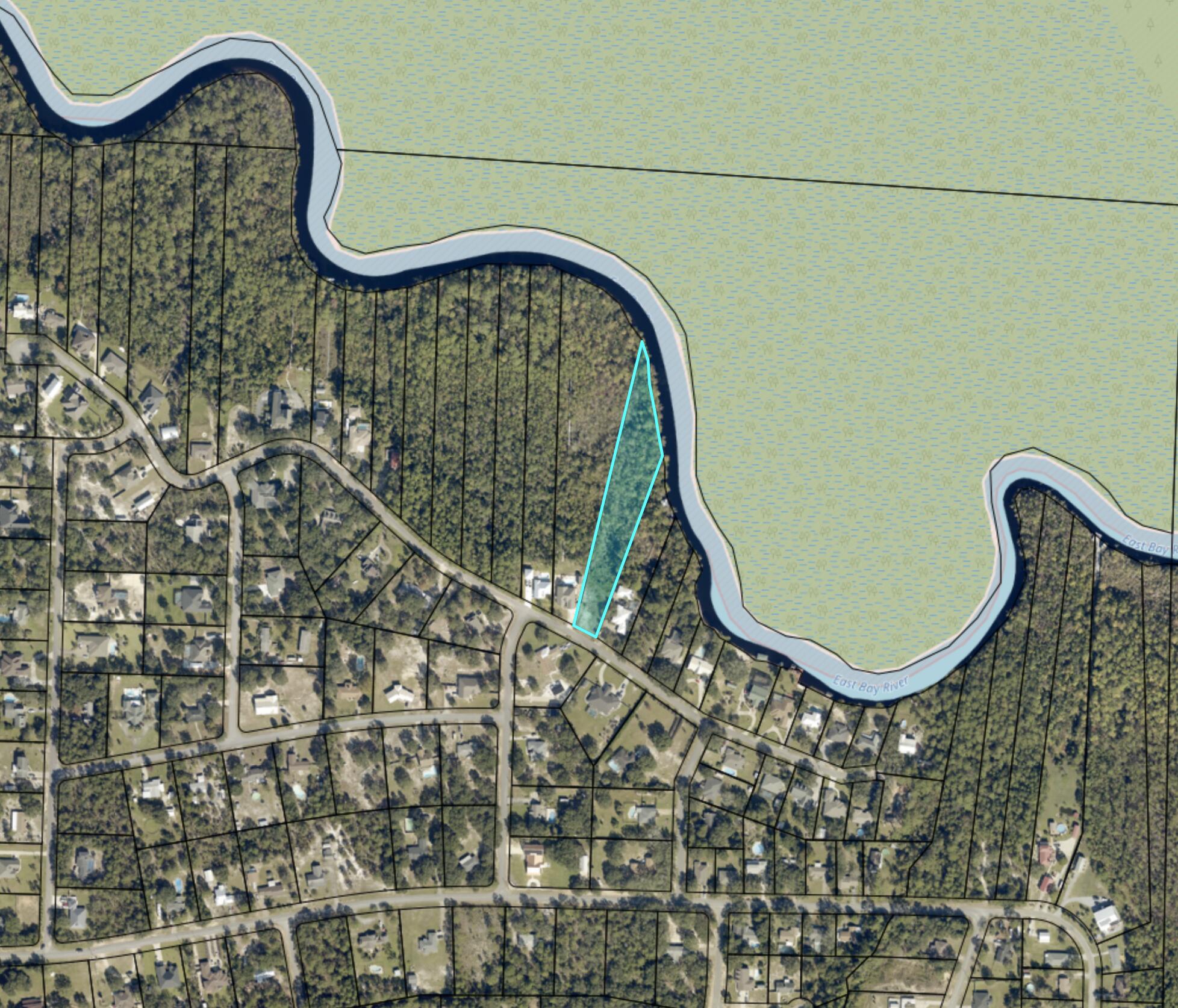 Riverfront lot in East Bay River Estates! Just minutes from the stunning beaches of Navarre Beach along the Gulf of America.