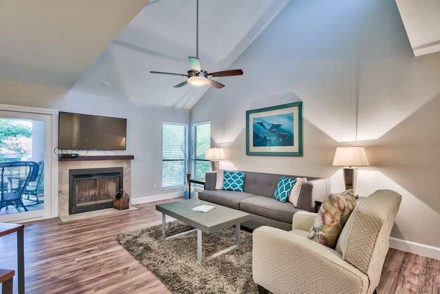 Incredible opportunity to own a beautifully remodeled 2-bedroom, 2-bath condo located in the coveted Tops'l Beach and Racquet Resort! This unit features vaulted ceilings in the living area and guest bedroom as well as new vinyl wood flooring and baseboard trim throughout. Off the living area and master bedroom is access to a private balcony overlooking the lake. This is the perfect place to relax and take in the serene views. The kitchen has been beautifully updated with recessed lighting, new cabinets, Quartz countertops, glass backsplash & high-end stainless steel appliances. Enjoy casual dining at the breakfast bar or there is an additional dining area for four near a sliding glass door that opens up to a smaller balcony. This unit offers a carport & storage area ideal for beach gear!