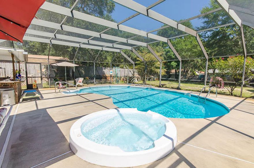 LARGE Saltwater Filtered POOL & HOT TUB with ENORMOUS Screened Enclosure for the OUTDOOR LOVER! Summer Kitchen w/ sink, mini-fridge, wine cooler & Bar Top for your Entertaining desires! Yard expands 75ft across the front & 150ft to the rear lot line with room to build garage or even mother-in law suite! Bonus Storage Building with Electricity! You will love all of the updates to include Tiled floors, Solid wood 6-panel doors and wood trim, double pane windows, tile accents around wood burning fireplace in Den, Large Laundry room with tons of cabinets and storage space. Expanded kitchen offers Breakfast Bar, Granite counter tops, custom birch wood cabinets to include pantry, GAS STOVE & Large dining area. French Doors Lead out to your Summer Abode! Home features Master Suit with double closets & exterior entrance to your private Pool & Hot Tub. Bedrooms in total with great closet space, updated tiled showers & modern vanities, guest bath has Jacuzzi! Most of the updates were completed in 2005 to include Tankless HOT WATER HEATER!!! Screened Sun Room Extends off the front of the home. This summer retreat includes tiled floor, fans & electrical outlets.  Double driveway extends large enough for an RV, Boat or up to 8 vehicles! Just outside front door is a small fish pond! Don't forget to say hi to the Fish! You can see the community park from the driveway & just a few blocks away you can enjoy "Meigs Beach". Come play in the sand, enjoy fishing & a picnic, even launch your boat in the Bay! Call to see today! More photos Available!
2015 Heater for Outdoor Jacuzzi
2009 New Salt Water Filter
2016 New Screens on Enclosure
2005 Roof, Kitchen, Appliances, Tankless Hot Water Heater 
2008 Bathroom Renovation