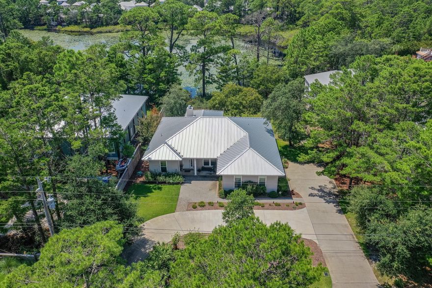 0.6 ACRES LAKEFRONT with westerly views.  This very well maintained home offers coveted privacy overlooking Hidden Lake. Imagine the outdoor living space you could have! Superb location off 30A, only .4 miles to the Public Beach, near hiking trails, and only .8 miles to Gulf Place! Located in a family friendly neighborhood this would make a perfect step down home or add on for additional sq footage. Upgrades include a new standing seam roof, spray foam attic insulation, air conditioning system, impact rated windows, sliders, and a new well pump to name a few. Beautiful landscaping with plenty of parking, another rarity for our area. If your looking for a quaint, clean, easy living home, that offers a large yard overlooking a lake, in addition to offering the best of 30A this is your home.