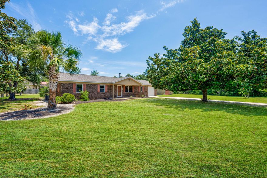 On 1.43 acres of land in Gulf Breeze, this property could be your perfect dose of tranquility. This 3-bedroom, 2-bathroom home offers a 3 y/o roof, 1981 square feet of living space and 400 sq ft of detached workshop space. New carpet (May '24) was installed in the Primary Bedroom, as well as a repaint and re-finishing of the back deck (May '24).  The garage has been partially converted, with partial sheetrock and recessed lighting. The 400 sqft workshop on property is the perfect space to house any sort of project. With electrical outlets, a work bench, and sliding partition doors, you have the freedom to express your creativity in a designated space! Some other notable features to mention on this home is the private access to the backyard from the Primary Suite, the centralized electric