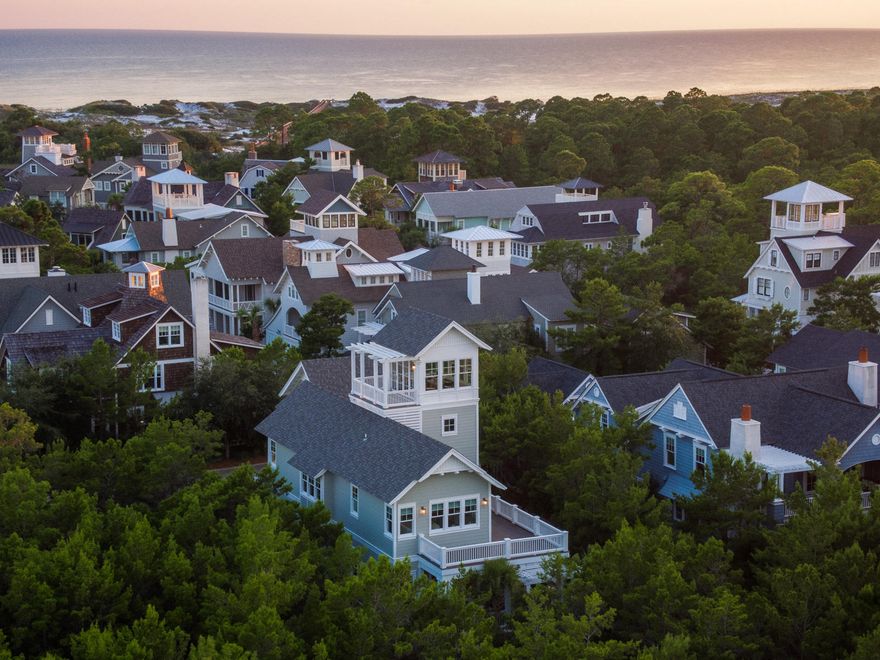 This enchanting Beach home features designer touches that showcase myriad fine architectural details. Ceiling beams complement the charming setting among indigenous Florida vegetation. Built-in features include a wine rack, multiple bookshelves and drawers, and entertainment system space create an ease of storage that combines efficiency with graceful style. Quartzite countertops, a Thermador appliances and clear glass globe pendant lights attest to high quality design and function throughout a bright, contemporary kitchen. Attractive bedrooms in soft sea glass hues beckon the weary at dusk and invigorate at dawn. Sleek, modern bathrooms are thoughtfully planned, and the oversized bunkroom is a versatile additional living area that includes media room entertainment systems. A charming  circular staircase rises from a screened outdoor living area to sun deck above, and the top of the world, fourth story glassed-in room soaring above the carriage house is perfect for sunset entertaining and star-gazing.  Besides exercising in a crystal clear private lap pool, one can polish golf skills at a landscaped putting course bordering the property that provides expansive green space.  Every Watersound Beach address radiates style, security and impeccable taste with nautical touches.  On more than 250 acres protected by unparalleled natural sand dunes, Watersound Beach residents enjoy an expansive, pristine beach, wood walkways and bike paths, fine dining and a chic lifestyle that embraces relaxation with a spirit of adventure.