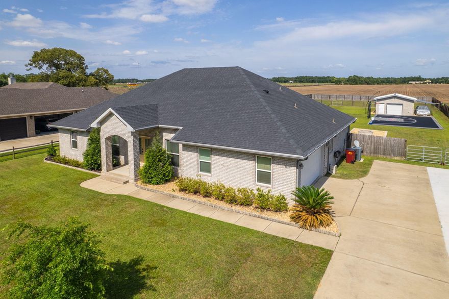 This stunning, extremely well-maintained home truly has it all--offering the perfect mix of comfort, elegance, and entertainment-ready features. Built in 2019, this spacious property includes 5 bedrooms, 3 full bathrooms, a large bonus room, an in-ground saltwater pool, and even a half-size regulation basketball court--situated on a fully fenced one-acre lot. With a 6-year-old HVAC system, roof, and water heater, you'll enjoy peace of mind from day one. Located on a quiet, low-traffic street in Pace, this home offers serene privacy. The interior is full of charm and craftsmanship, including detailed masonry work and high ceilings that create a sense of openness and style throughout. The thoughtful floor plan includes a spacious living area that flows seamlessly into a generous bonus room--i deal as an office, game room, or second family room. The kitchen is a true highlight, featuring crisp white cabinetry, stainless steel appliances, a walk-in pantry, and an adjacent dining area that makes hosting a joy. The split floor plan provides added privacy, with the luxurious primary suite offering a large walk-in closet and an ensuite bathroom with two separate vanity areas, a garden tub, and a huge walk-in shower equipped with dual showerheads and a central rain head. Step outside into an entertainer's paradise! The screened-in back patio includes an outdoor kitchen complete with a built-in refrigerator and sink. The backyard is fully loaded with a sparkling in-ground saltwater pool, built-in bar area, firepit zone, and a half-size regulation basketball court. The fence line is equipped with Mist Away - ensuring no mosquitos!  A large detached garage with a 10-foot bay door and attached carport provides ample storage and workspace. Additionally, there's a separately fenced areaperfect for pets, chickens, or even horses. This home is move-in ready and packed with features that make everyday living feel like a retreat. Don't miss your chance to own this exceptional property!
