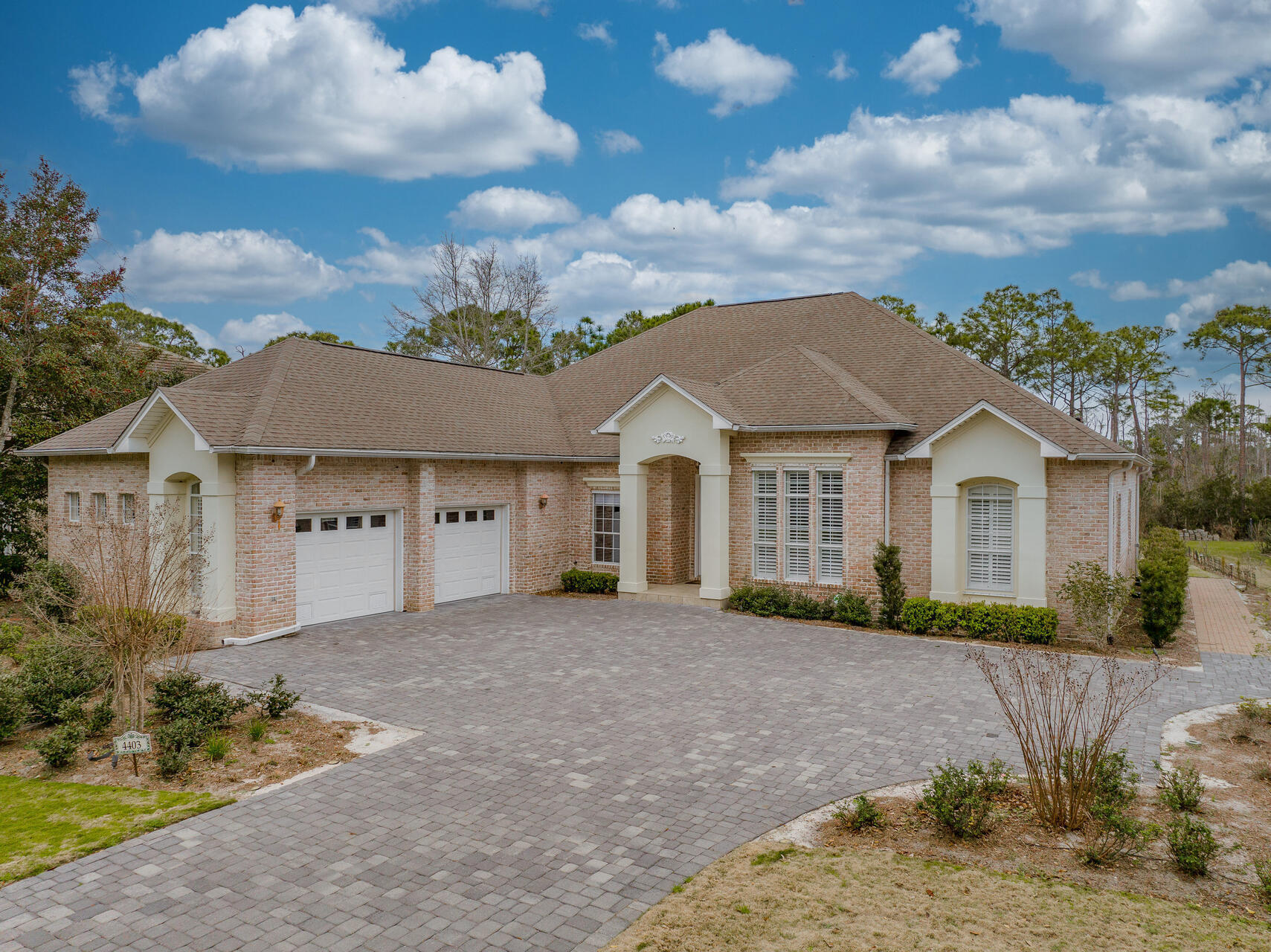 Classically elegant brick home with 2 car garage in the quiet gated golf community of Kelly Plantation. Spacious front yard and elegant brick covered patio out back that overlooks the greenery of the nature preserve and yields lots of relaxing space to decompress. Enjoy the scent of your own fruit trees including tangerine, grapefruilt, lemon, lime and orange. Open floor plan with natural light streaming in through the large windows of the breakfast nook. Master bedroom and large bathroom with custom closet are located on one end of the home and additional rooms on the opposite end providing privacy to you and your family or guests. Beautiful hardwood floors run throughout the living area, kitchen and bedrooms. The hot water heater and AC have been recently replaced.