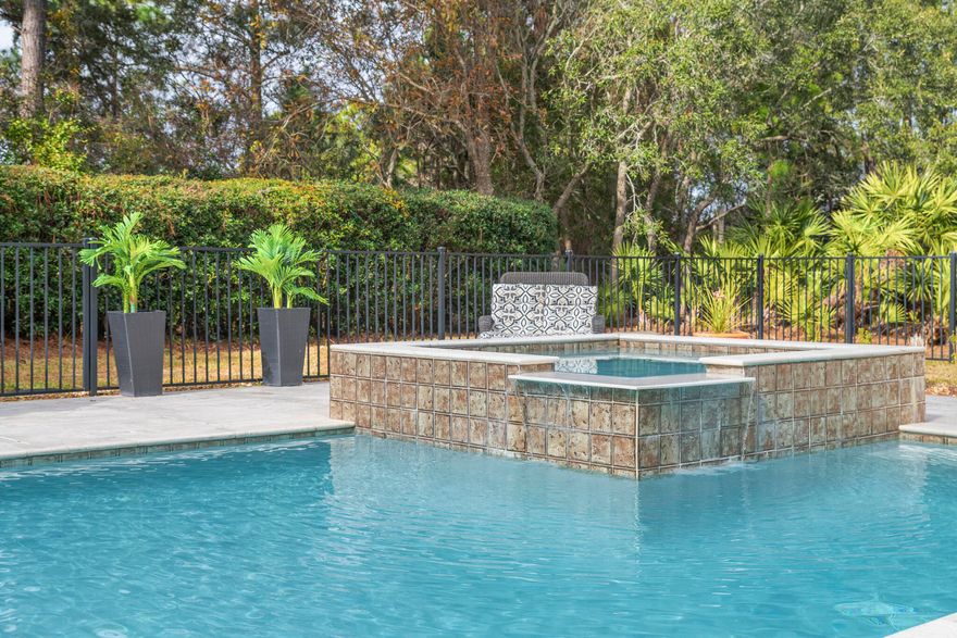 PRIVATE OASIS retreat with massive Heated Pool/hot tub in the gated Golf Course Community of Emerald Bay. Lush greenery shields views from neighbors. Double, screened lanai w/ multiple fans. Master suite on 1st floor. Bonus family room/office w/ bright view of pool. Circular drive outside Grand Entryway greets guests.