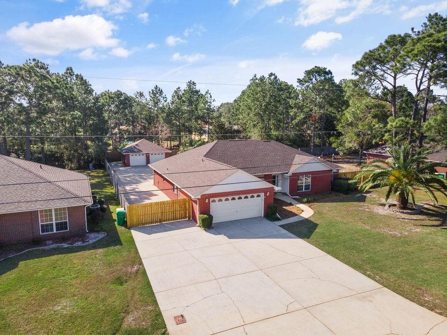 Take a look at this large 4 bed, 2 bath, 2,801 sq brick home with a brand new roof in the middle of Holley By The Sea.  The master bedroom is a massive 21'x19' with a large master bathroom and substantial walk-in closet.  On top of the standard 2-car garage up front there is a 25'x25' detached 2-car garage/workshop in the back.  With over 103' of concrete along the side of the home, there is parking for all of your toys, boats, RV's etc!  At the rear of the house there is a converted Florida room wrapped in windows and the backyard has plenty of room for a pool!  New Roof installed 4 months ago! Water heater is a 2016.  The gutters have a gutter guard system to keep trash out.Buyer to verify all measurements.