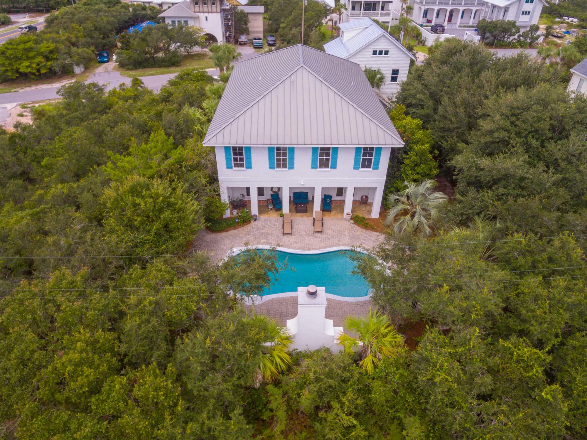 Spectacularly large luxury home with new detached 2.5 car garage and carriage house. Fabulous Caribbean estate feel with front porches upstairs and downstairs spanning the length of the home, and a gorgeous outdoor fireplace. A primary residence now but this home can make an incredible rental property. With 6 bedrooms, 7 bathrooms, multiple living spaces, two kitchen areas, a game room, and dining seating for 30 people, multiple families can comfortably vacation here. Beautiful beach decor with the finest quality finishes. Convenient to Alys Beach, Rosemary Beach and close to the beach.