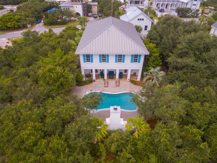 Spectacularly large luxury home with new detached 2.5 car garage and carriage house. Fabulous Caribbean estate feel with front porches upstairs and downstairs spanning the length of the home, and a gorgeous outdoor fireplace. A primary residence now but this home can make an incredible rental property. With 6 bedrooms, 7 bathrooms, multiple living spaces, two kitchen areas, a game room, and dining seating for 30 people, multiple families can comfortably vacation here. Beautiful beach decor with the finest quality finishes. Convenient to Alys Beach, Rosemary Beach and close to the beach.