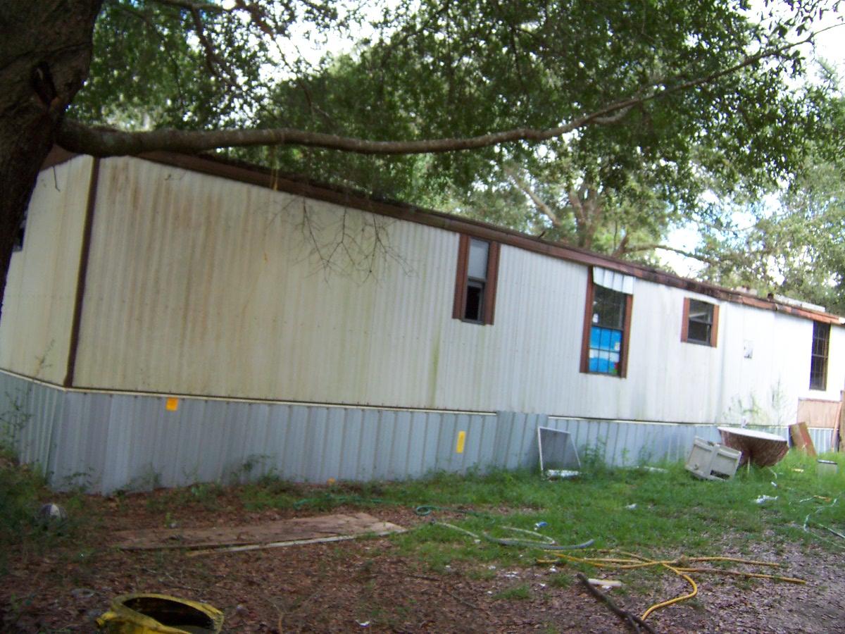 Over an acre of level land on paved road in excellent location in Mossy Head area. Currently 2 attached mobile homes located on the property with no value given to them. However utilities are in place for them. Property has driveway, septic, water, and Power, also some clearing and fencing. Mobile homes are in poor condition and will not qualify for any financing. Cash only.
