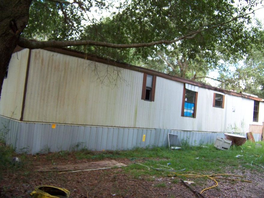 Over an acre of level land on paved road in excellent location in Mossy Head area. Currently 2 attached mobile homes located on the property with no value given to them. However utilities are in place for them. Property has driveway, septic, water, and Power, also some clearing and fencing. Mobile homes are in poor condition and will not qualify for any financing. Cash only.