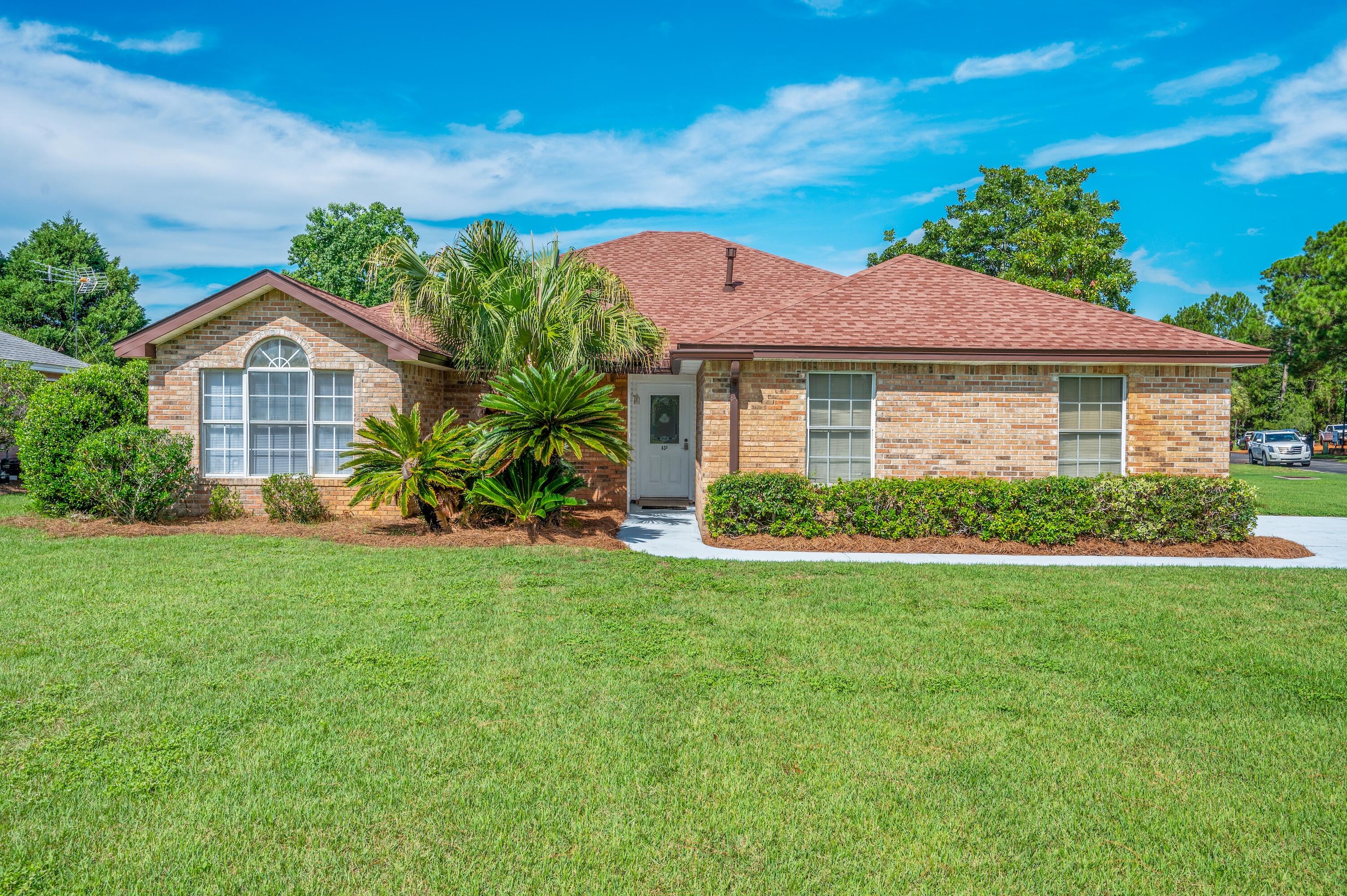 Enjoy the Sunsets over the Bay from this spacious Brick home, on an oversized corner lot and across from the Community Dock! Fireplace, vaulted ceiling, split bedroom plan, natural gas stove and outdoor grill hookup on the screen back porch. Newly painted interior, roof replaced in 2024 and carpet in early part of 2025. Community Amenities include tennis courts, pool and picnic area - just a short distance from this lovely home. Silver Sands Outlet Mall, restaurants, grocery and Beach access are only a few blocks away. Easy access to Hwy 98 with a traffic signal at the subdivision entrance. This home is priced to sell and is ready for your own customization and renovations. Waterfront conveniences without the Waterfront Price! Come view this home before its gone!