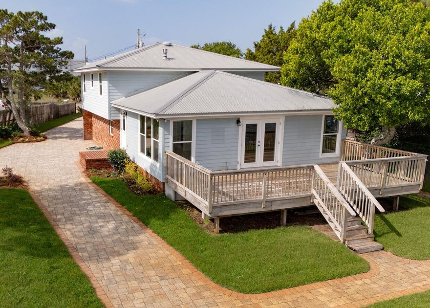 Here is the unicorn waterfront property you've been looking for! On beautiful Okaloosa Island, this 3-bedroom, 3-bath home overlooks the serene Intracoastal just across from the Landing. With 102 feet of waterfront, this property is uniquely situated to offer 180 degrees of panaromic sunrise and sunset views. The deep water dock provides 4 wet slips. Covered aluminum QAB boat lift system can handle up to 20,000 pounds. The dock also boasts a 200-amp electrical service. Just a short walk to the famous sugar-sand island beaches, this home has everything you're looking for in waterfront living. The beautifully renovated interior offers an expansive kitchen and living area with high impact hurricane windows and double French doors (also hurricane rated) for plenty of natural light. Quartzite countertops, stainless steel appliances, and custom wood cabinets provide the Chef with a convenient, modern kitchen, including a 5-burner range and Bosch dishwasher. Enjoy those spectacular views without leaving the kitchen!
The oversized primary suite has his and her closets and an updated bathroom with quartzite, lovely wood cabinets, hexagonal tile floors, and new light fixtures. All 3 bedrooms have gorgeous engineered hardwood flooring. 

Oversized garage has plenty of room for kayaks, paddleboards, and other water toys in addition to your vehicle. The third bathroom is just off the garage and is easily accessible from the living space, while also providing convenient access from outdoor activities. A hurricane-rated garage door has also been installed. 

With one of the longest waterfront footages on the Island, the exterior is just as lovely as the interior, with brand new landscaping and sod and a firepit overlooking the water. A fence with gated access provides extra peace of mind. The dock will accommodate your 100-foot yacht or several smaller water toys - or anything in between. A deck overlooking the water is perfect for entertaining. The striking paver system provides plenty of parking and is rated for high-weight commercial loads.
