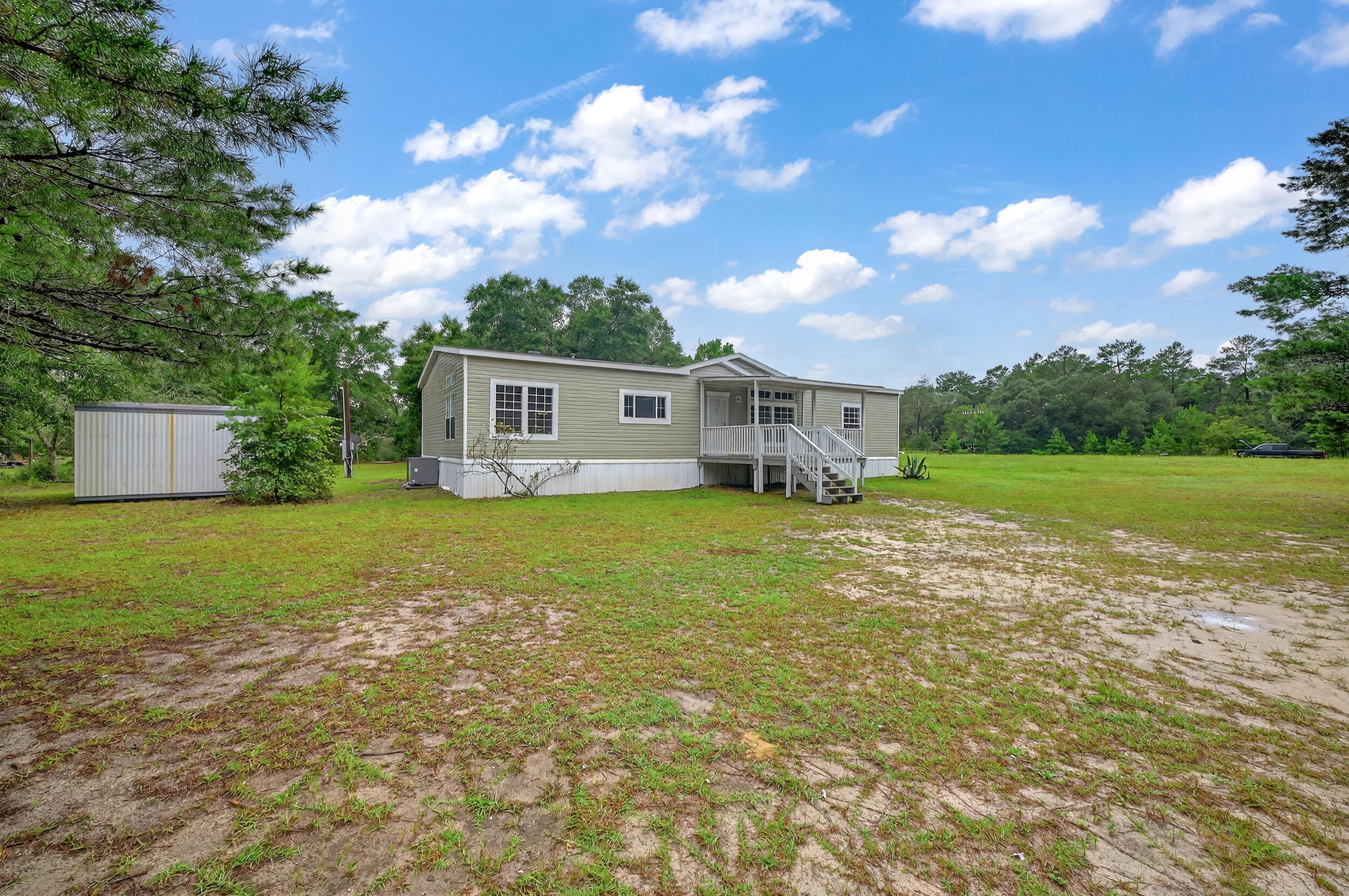 Experience peaceful country living with this well-maintained 3-bed, 2-bath 2010 manufactured home offers approx. 1,800 sq ft of comfortable, single-level living on a full 1-acre lot. New roof before closing, all new LVP and carpet throughout and Enjoy a spacious, open layout, split-bedroom design, and plenty of natural light. The large primary suite features a private bath, while two additional bedrooms offer space for family, guests, or an office. Central heat/air and easy-care flooring add comfort and convenience. Outside, the expansive yard provides room for gardening, pets, or simply relaxing in your own private space. Located just minutes from town yet surrounded by nature, this property offers the best of both worlds--affordability, space, and tranquility.