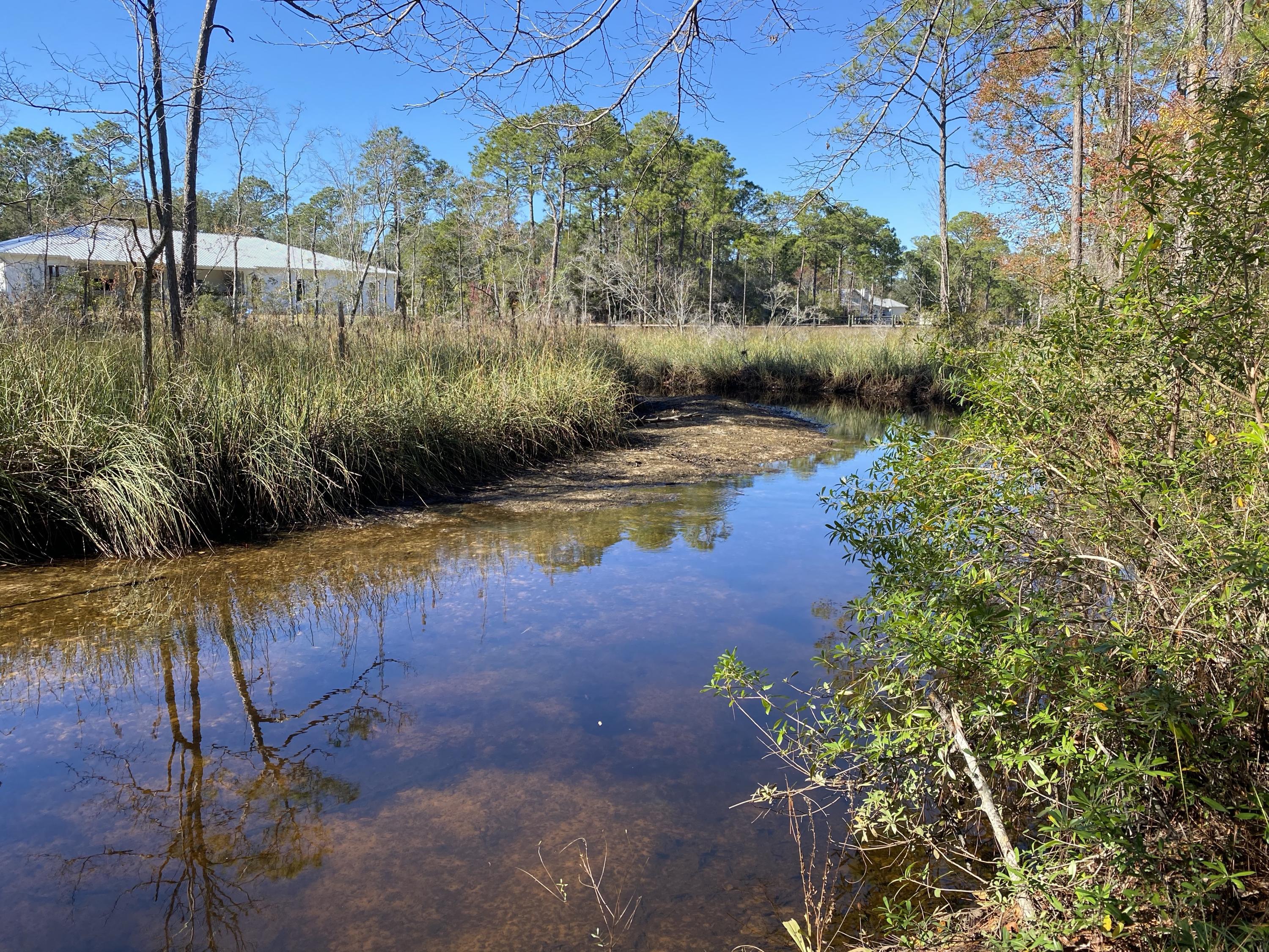 This is the perfect lot to build your dream home on the Emerald Coast! This property has beautiful mature trees and water frontage on a canal where you can launch your paddle boards and kayaks and take them right out to the Choctawhatchee Bay!