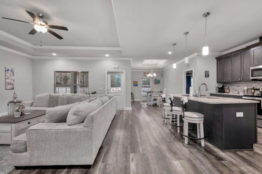 Discover unparalleled elegance in this Stunning, like New, 2022 Craftsman Style Home on a 0.46 acre lot. Step into the Grand Hallway that leads to the expansive Great Room featuring trey ceilings, separate dining area and designer finishes. You'll love the Luxury Vinyl Plank floors, with tile in wet areas and carpeted bedrooms. Feast your eyes on a Chef's wish list Gourmet Kitchen with stainless appliances, granite counters, a large walk-in pantry, breakfast bar and Farmhouse sink. The spacious Master Suite is a slice of heaven with it's en-suite bathroom featuring twin vanities, a big garden tub perfect for bubble bath enthusiasts, along with a custom tiled walk-in shower, WC and a closet so big it has its own zip code and leads straight into the laundry too!