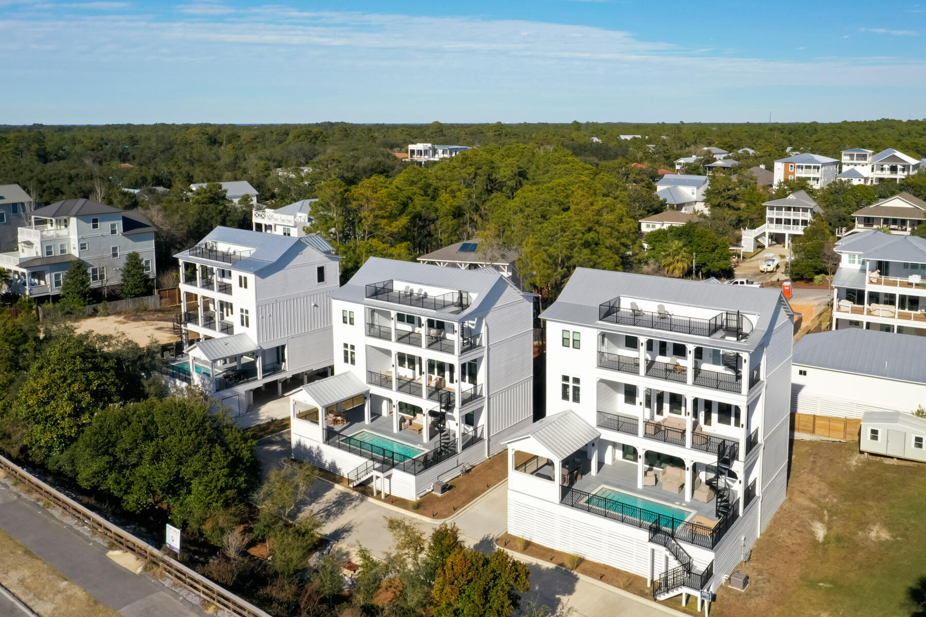 Here is your chance to own TWO stunning, new homes located directly on 30A! Whether for yourself or to use as an income producing property, having a total of 10 bedrooms, PLUS two bunk bed rooms, and two private pools provides limitless options. With projections at upwards of $250k per house, renting these homes together would be a rental machine! Enjoy overlooking County Highway 30A from the back porch, with Gulf Glimpses from multiple spots at each house. To top it off, there are no assessment fees because there is NO HOA! Both of these homes are being sold fully furnished with top of line decor and finishes, a Chef's kitchen with luxury appliances, two washers/dryers, two living areas with a kitchenette on the pool deck as well as outdoor kitchen, it is an entertainer's dream. Only a short walk or bike ride to the beach and also to Gulf Place with several renowned restaurants shopping, and more. Make an appointment to see these homes today!