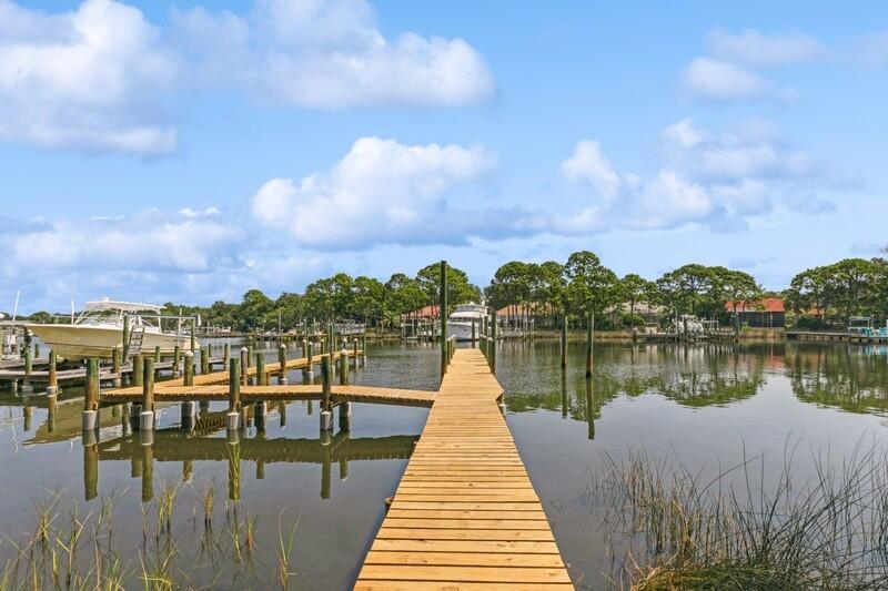 Just image having your morning coffee while seated on your screened porch just off your spacious elegant bedroom.  Looking out past your private pool, you see your beautiful boat calling your name.  At the edge of your backyard is your private dock located on your 100 feet along the serene deep water of Indian Bayou.  In a matter of minutes, you could be boating on the bay!   This very tastefully decorated home located in the coveted Indian Bayou Subdivision has a lot to offer.   You will find ample living and entertainment space.  Stepping inside, you have an office to your left and a dining room to your right.  Straight ahead is a generous size great room with a cathedral ceiling peaking at over 12 feet.  The sunroom with its wall of windows overlooking the pool and bayou