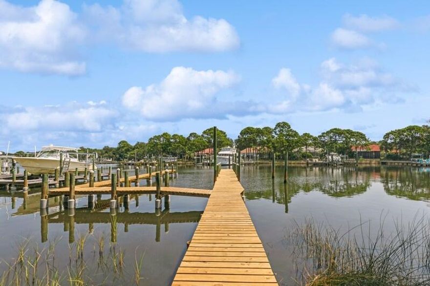Just image having your morning coffee while seated on your screened porch just off your spacious elegant bedroom.  Looking out past your private pool, you see your beautiful boat calling your name.  At the edge of your backyard is your private dock located on your 100 feet along the serene deep water of Indian Bayou.  In a matter of minutes, you could be boating on the bay!   This very tastefully decorated home located in the coveted Indian Bayou Subdivision has a lot to offer.   You will find ample living and entertainment space.  Stepping inside, you have an office to your left and a dining room to your right.  Straight ahead is a generous size great room with a cathedral ceiling peaking at over 12 feet.  The sunroom with its wall of windows overlooking the pool and bayou