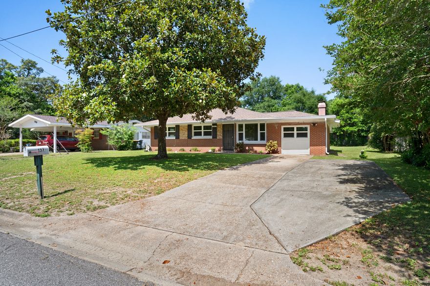 PRICE IMPROVEMENT & SELLER TO GIVE $10,000 FLOORING CREDIT @ CLOSING. A well loved and maintained brick home snuggled into a nice established neighborhood has many updates:  ROOF 2019, GAS WATER HEATER 2016, HIGH IMPACT WINDOWS 2015 and new kitchen cabinets/granite counters!!  This ranch style home boasts a spacious dining/living area w/wood burning fireplace and a small spot built under an area of flooring which can be used for an hidden storage space.  Down the hallway at the back of the house is a large master suite that includes two closets.  ALL of this on a spacious lot!  The main waterline from the street to the house was replaced in 2010!!  The lawn pump is not operational and will be AS IS. This gem is ready for you to call this home!!  TERMITE BOND transfers
