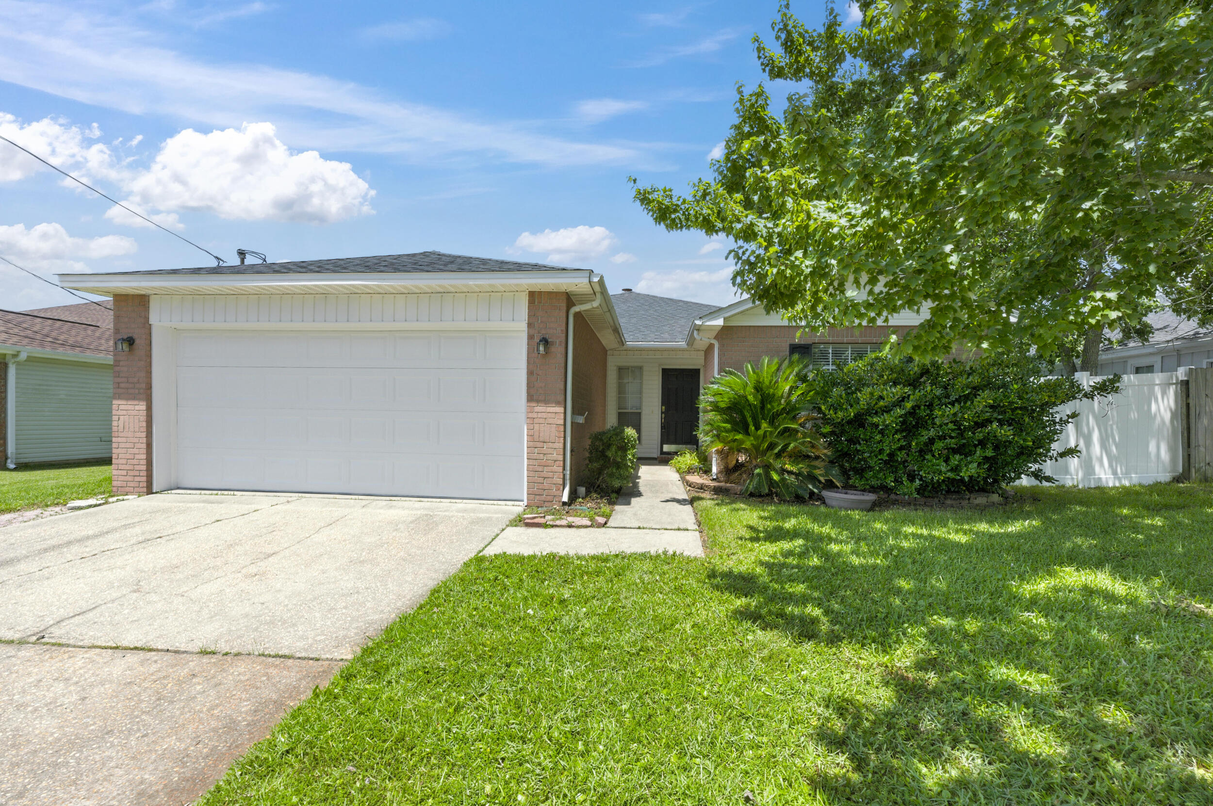 Move-in ready & just 2 miles from Hurlburt Field! This charming 3BR/2BA brick home offers a 2023 roof, spacious living room with vaulted ceiling & cozy fireplace. The kitchen includes ample cabinet space, breakfast bar, and pantry/closet off the dining area. Sliding glass doors lead to covered back porch and fully fenced backyard--great for pets, kids, or entertaining. The generous primary suite features a walk-in closet, double vanity, and relaxing garden tub. Two guest bedrooms share a well-placed hall bath. Laminate flooring in living areas and bedrooms, vinyl in kitchen, baths, and laundry. Large laundry room with shelving for storage. Around the corner to top-rated schools, shopping, restaurants, medical care, and our beautiful white-sand beaches of the emerald coast!