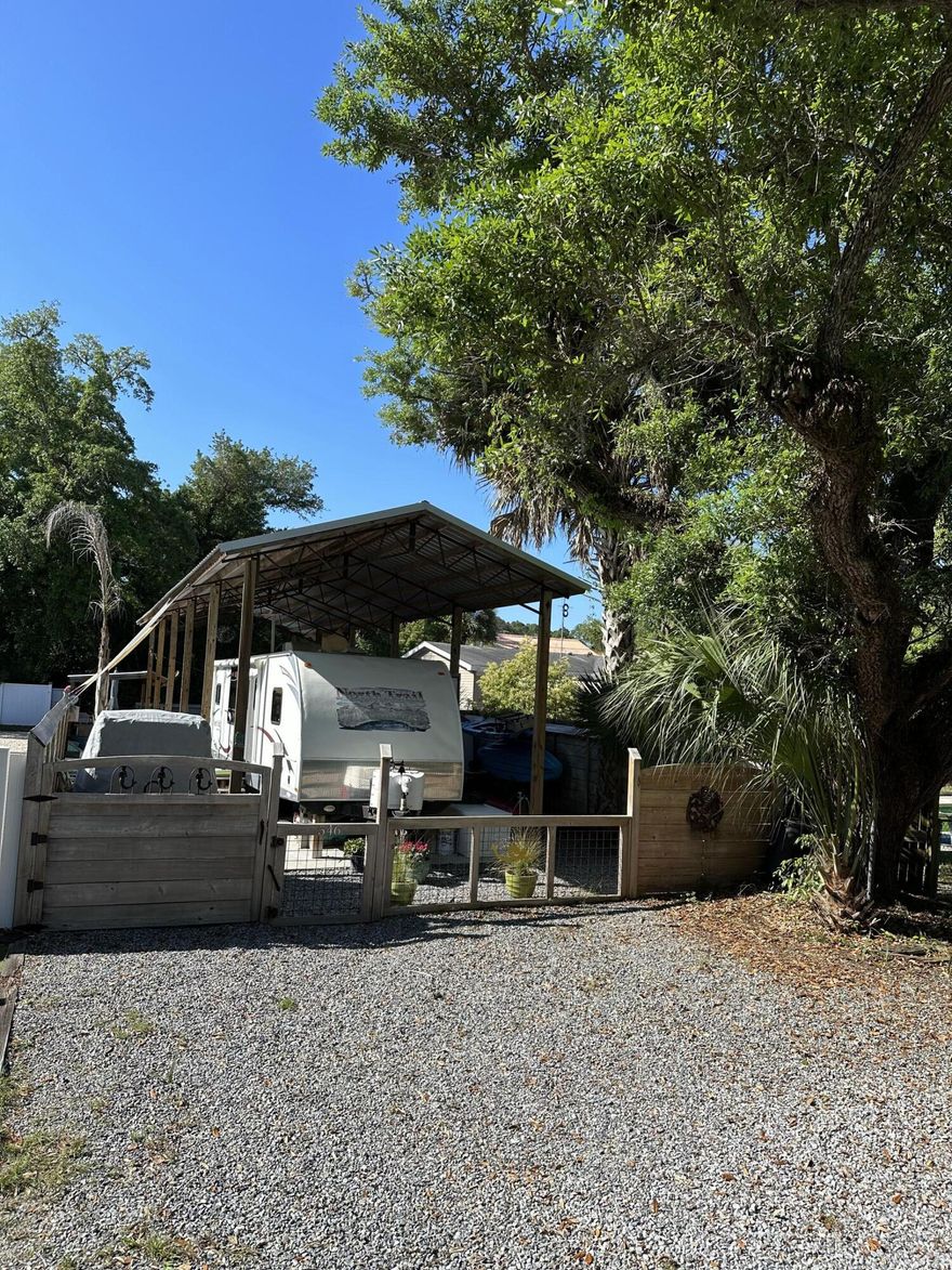 Incredible turn key and improved RV site in the Oak Grove community that is an easy golf cart ride to historic downtown Port St Joe, FL. A MUST SEE!!  Amenities include: 60'x15' pole barn with steel reinforced concrete slab, 6' cypress fenced perimeter with removable front for RV, golf cart gate, landscaping, multiple wooden decks, St Augustine grass, granite rock accents.  Other buildings, covered cypress cook station with metal roof for multiple cooking options, 24'x7.5' outbuilding that surrounds an outdoor TV area with full bath, marble floors, and floor to ceiling tile, all doors and windows are impact glass and fully synthetic material doors and trim, Dekton countertop in outdoor kitchenette, Laundry room with stackable washer and dryer.  Smaller storage options for kayaks and tools as well.  Think of all the time you can spend enjoying the best that coastal RV life affords just in time for the season with no waiting around for improvements or delays from contractors.  CALL TODAY!