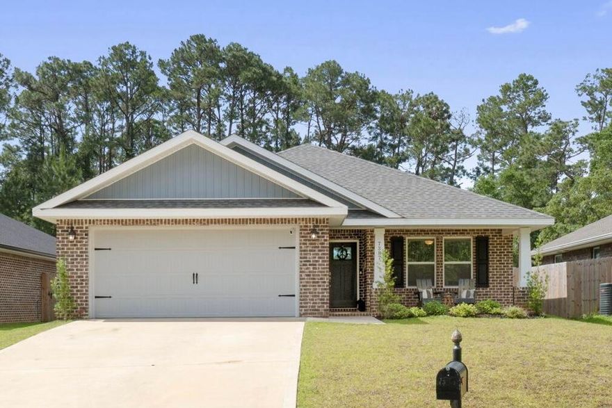 Welcome home to this stunning and practically new home on a 0.36 acre lot with no HOA! Built in 2021 this all brick 3 bedroom 2 bath brick home offers exactly what you are looking for with the high end finishes you want. Enjoy an open living room with a soaring vaulted ceiling and recessed lighting open to the dining room and kitchen space adorned with luxury vinyl plank flooring. The kitchen features solid wood cabinets with soft close doors and drawers and granite counters as well as drop down pendant lighting and brushed nickel hardware. You will love this owner's suite featuring a door out to the patio and a trey ceiling with accent lighting! The owner's luxurious bathroom is a dream with a separate garden tub, a walk in tiled shower with dual shower heads, double vanities with granite counters, a private water closet, and two walk in closets! The other two spacious bedrooms with ample closet space are located on the other side of the house with a shared full bathroom between them. The interior laundry room is off the kitchen and leads to the two car garage. Outside you will love the covered patio with a nice private view and no backyard neighbor. The backyard has a privacy fence and the property line extends past the fence line! Don't delay on this gem, enjoy being a short drive to Hurlburt Field and only minutes to Navarre Beach!