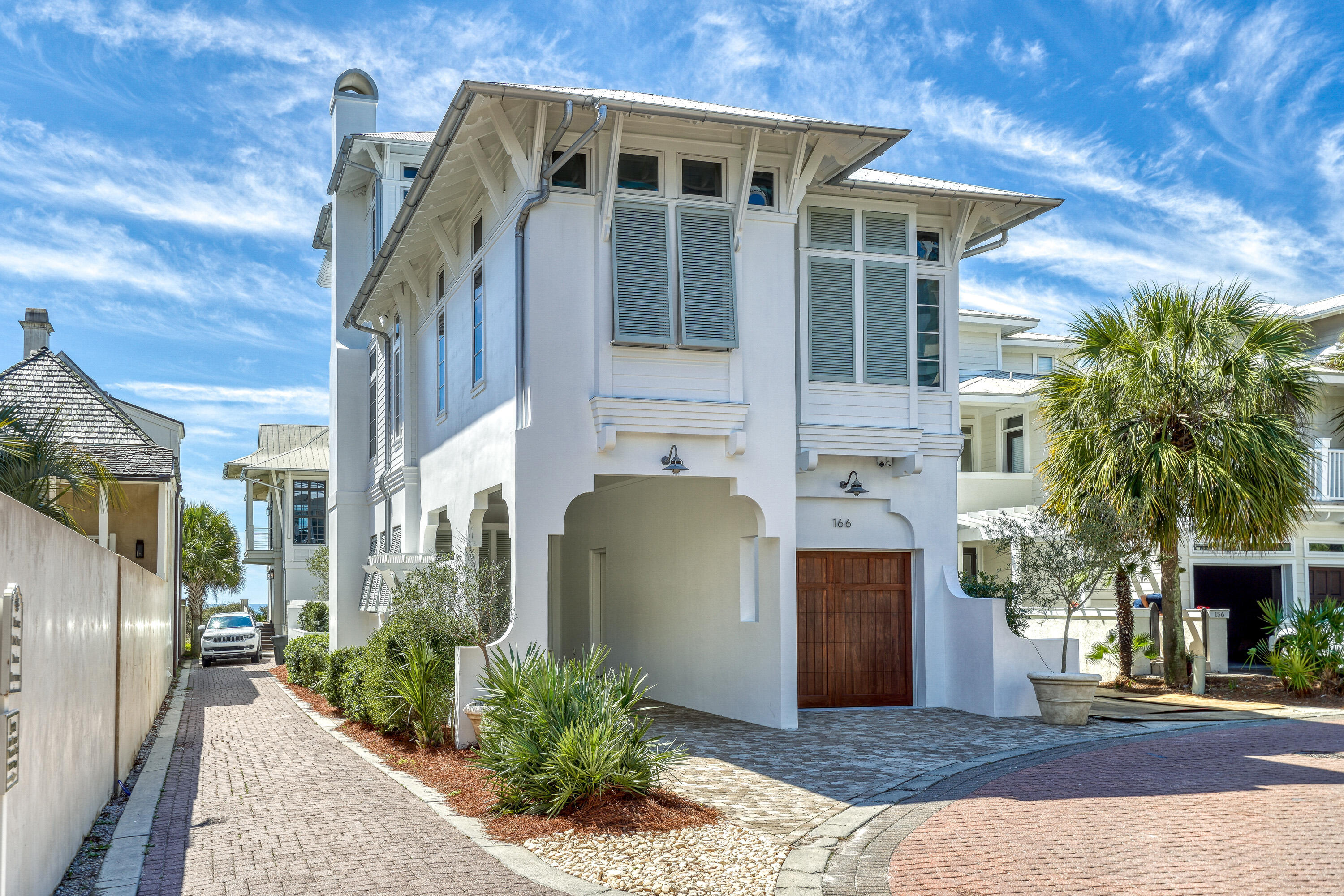 One back from the Gulf in the exclusive, gated community of Water's Edge, this stunning three-story coastal retreat offers the rare combination of luxury, privacy and direct access to the best of 30A. Perfectly positioned between the iconic communities of Rosemary Beach and Alys Beach, the home captures expansive Gulf views from multiple levels and sits just steps from the private beach access. With only a two-story home in front, this three-story luxury residence enjoys expansive Gulf views from all over -- a true rarity on the second row. Designed by architect Tyler Doin and built by Suntec, the home features 5 bedrooms (4 king suites + 1 bunk room) and 5.5 bathrooms, and comfortably sleeps 12. Highlights include a chef's kitchen with pecky cypress accents, smart home technology and a wall of folding glass doors opening to a Gulf-facing porch. The third-floor primary suite is a private sanctuary with a sundeck, sleeping porch, wet bar and soaking tub. Outdoor living is equally refined, with a heated pool and spa, summer kitchen, fireplace, and teak lounge areas. Additional features include impact-rated windows and doors, 10'-13' ceilings, a dumbwaiter, laundry chute, and full designer furnishings by Heather Lollie. Consistently ranked among the top luxury homes in the Rosemary Beach rental program, this property offers proven income and an exceptional coastal lifestyle in one of 30A's most desirable communities.