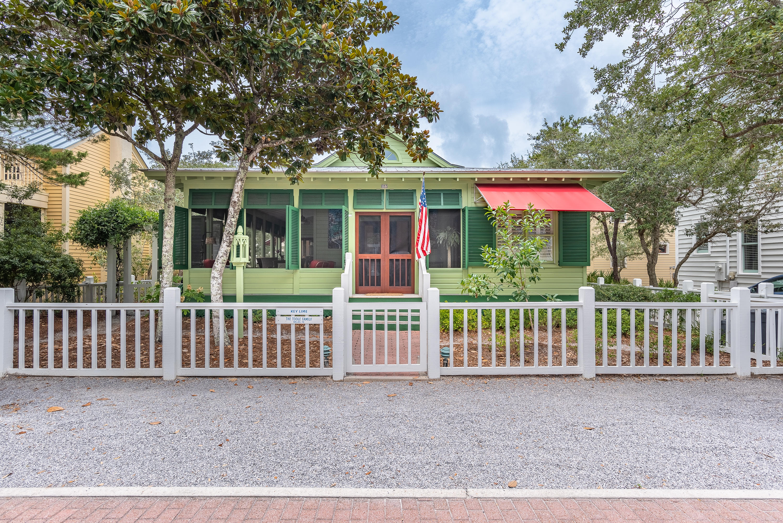Located in Seaside, Florida, recently named ''The prettiest town in Florida'' by ARCHITECTURAL DIGEST. This comfortable beach bungalow with wraparound porches and operable shutters closely follows the traditional vernacular cottages built generations ago in waterfront towns along the Panhandle. The generous side yard deck maximizes outdoor living. Step through the double mahogany screen doors and into a deep front porch and the magic of the house unfolds. The interior is arranged with a continuous living and dining space at the center of the house with soaring ceiling and cypress beams adding volume and a sense of drama. Custom mahogany French doors in the living room and each of the bedrooms swing out to savor the outdoors. V-groove wood walls and ceilings and maple