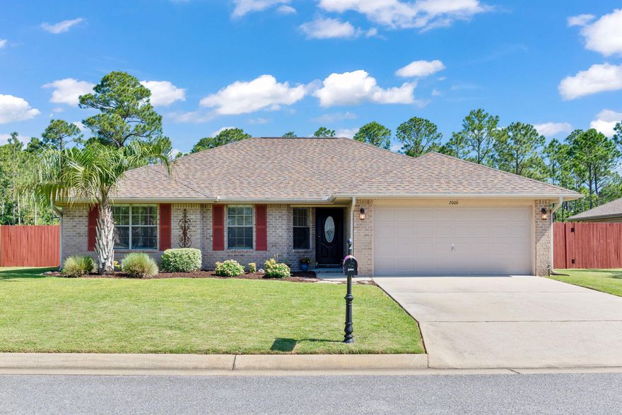 Multiple Offers!! Encounter comfortable living that is defined in this impeccably well-maintained traditional brick resting in the friendly community of Bay Pines. Feel more at home in this cozy, yet spacious floorplan where the square footage has beenfantastically utilized to appease any owner. You'll be delighted by the eye pleasing attractive grounds that features asprawling green lawn, lavish tropical landscaping, and low maintenance brick and vinyl siding that is perfectly set amidst awooded setting and perfectly framed by charming crimson shutters and coordinating fence. Your welcomed to the home by awarm foyer that is immediately preceded by an amazing open and cheerful floorplan that is beaming with natural light and alarge, peaked ceiling for spaciousness. You can enjoy  the best gathering with friends and family in the generous space that is open to the dining area that both overlook the sightly backyard. The home features homely carpet that has been wonderfully kept and stress-free vinyl flooring in the wet areas. The dining area gives immediate way to the roomy kitchen that is most practical with three walls of maple cabinetry containing easy care Formica countertops, stainless steel appliances, neutral glass backsplash, and above the sink window that allows flowing natural light. This fantastic split floorplan makes owners privacy delightful. On the left of home, you will find a hallway that leads to the two guest rooms that contain sizeable room and closet space as well as a shareable full bathroom that features shower/bath combo. Storage is made easy as the home features linen closet space in the hall as well as an entryway coat closet. Opposite the home is the master's suite that contains an ample light filled room complete with a ceiling fan and his and her walk-in closets. The adjoining master ensuite is spacious and entails a large double vanity sink, linen closet, and large glass enclosed shower. From the master, there is easy access to the large laundry room that features plenty of storage space and leads to the large two-car garage. From the main living you find access to your private lanai that overlooks a picturesque landscape that backs up to wooded tall pines. Sip your coffee and watch the birds while unwinding after a long day enjoying nature amongst the large, covered lanai with ceiling fan that is perfect for a large patio furniture and grilling. Bring any of your landscaping ideas to add to the charming brick pavers that surround the outdoor lanai and entrance. There is a convenient shed that is great space for storage of yard tools as well as large side yard to enjoy any outdoor activities. Centrally located to everything in Navarre and short drive to beautiful beaches and Hurlburt Field. Call today to schedule a private showing before this affordable home is gone!