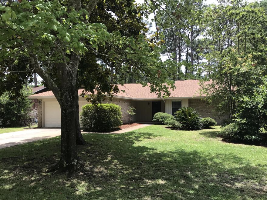 PRICE Reduced !! MOVE IN READY !! This beautiful, well maintained home has TRAVERTINE tile throughout the living areas and Granite counters with tile backsplash in the kitchen. The home has an open floor plan with large living space boasting a wood burning fireplace and a cathedral ceiling. The master bedroom has a full bathroom and a large walk-in closet. There is a screened tiled porch that opens to a fenced, private, wooded back yard. NO HOA fees, this quiet community is close to schools, shopping, golf, boat launch, fishing, nature walk, and more. Overall this is a great home in Bluewater Bay for a great price.