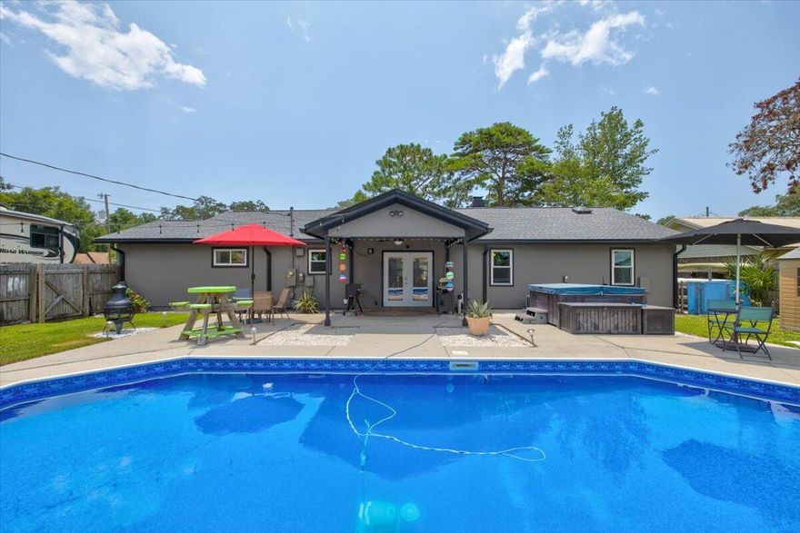 Beautiful saltwater pool home located on a huge corner lot in a great neighborhood that is conveniently located to beaches, schools, shopping and more  - but is tucked away on a no thru-traffic street. This lovely home features new roof, gutters, windows (with hurricane fabric), interior and exterior paint, remodeled bathrooms with new skylights, new barn doors in the master bedroom along with the new cedar-lined walk-in closet. The spacious living room with wood burning fireplace PLUS the huge den/bonus/room provide lots of space for living and entertaining. There is a new pool liner and filter and pump ... and the list continues. Complete with a 2-car garage, and additional parking - a privacy fence in the back yard with pool and hot tub, This home is move-in ready and waiting for you