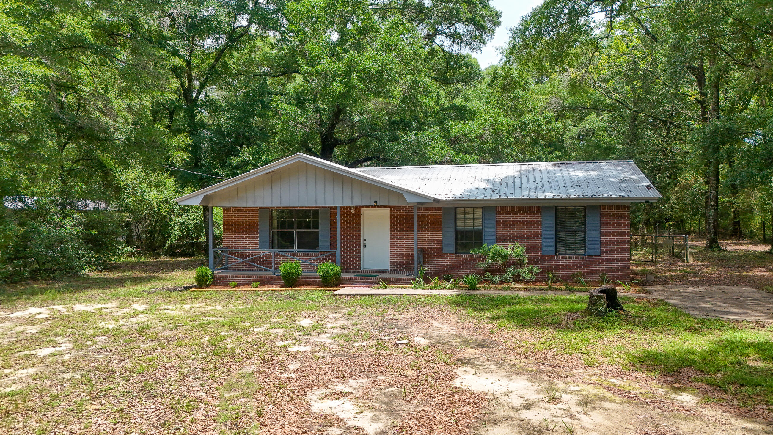 This beautifully maintained ranch-style home is on just under 1 acre and is perfectly located just outside the quaint city of DeFuniak Springs. Surrounded by peaceful countryside, the property features a generous living room with 3 bedrooms and 1 and 1/2 bathrooms. This home has new flooring and no carpet! Additionally, it has a brand new water heater and electrical box. Tucked away in one of the most tranquil areas of the Florida Panhandle, this home offers both privacy and charm.