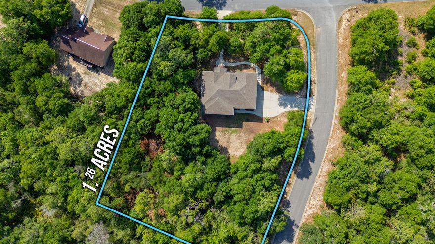 Custom-built luxury farmhouse Craftsman on over an acre with a clear, spring-fed creek and exceptional privacy. Brick and siding exterior with wide, gracious porches ideal for quiet mornings and inviting outdoor living. Meticulously clean and maintained this thoughtfully designed home features a two-level floor plan with charming upgrades throughout. Stunning chef's kitchen featuring expansive granite countertops, copper farmhouse sink, touch-free stainless appliances, farmhouse-door pantry, and 42'' cabinetry. Bright, well-appointed laundry room with custom built-ins, granite surfaces, and space for a freezer. Includes two living areas, 5 spacious bedrooms plus office, 3 full baths, and 1 half bath--offering space, and timeless character.  Love your next home.