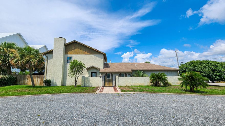 Coastal Living at Its Best! Welcome to your dream beachside home on beautiful Okaloosa Island! This spacious 4-bedroom, 2.5-bath home is perfectly positioned just steps from public beach access, offering effortless enjoyment of the white sand beaches and emerald waters of the Gulf of America.Upon entry, you're greeted by a main-level bedroom and convenient half bath, ideal for guests or a home office. Just beyond, a dedicated dining area sits adjacent to the kitchen--offering separation while still maintaining great flow for entertaining and everyday living.The gourmet kitchen features granite countertops, a center island with smooth-top range, stainless steel oven with overhead venting system, breakfast bar, built-in desk area, and plenty of cabinet space--designed for both function and style.

The living room is warm and welcoming, anchored by a wood-burning fireplace, perfect for cozy evenings. 

Upstairs, the spacious master suite includes a tiled walk-in shower, while two additional bedrooms share a full bath which provides plenty of room for family and guests.

Step outside and expand your living space with two covered patios, ideal for entertaining or simply relaxing in the hot tub. 

Whether you're searching for a full-time residence, vacation getaway, or investment opportunity, this island retreat has it all. Schedule your private showing today and start enjoying the laid-back, coastal lifestyle of Okaloosa Island!