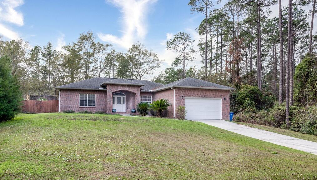 Beautiful, all brick home offers an open floorplan, formal dining room, living area with fireplace, and kitchen has ample cabinet space, pantry, stainless steel appliances, & island with granite top & bar seating.  Split bedroom layout features spacious master bedroom with a walk-in closet & bathroom with dual sink vanity, walk-in shower, & garden tub. Huge screened in porch out back with additional patio, fire pit, fenced yard all sitting on large .35 acre lot surrounded by trees/shrubs!  Seller has updated home with the following: new carpet in bedrooms, shelving in closets & laundry, toilet & storage cabinet in master bath, ceiling fans in LR/BR, dishwasher, thermostat, clean out valve for septic tank & river rock added to front flower bed.  Call today to schedule your private showing!