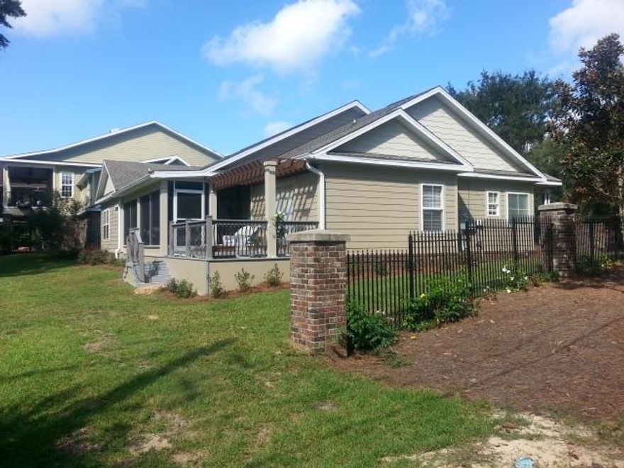 Better than new with a bayou view! Enjoy the casual elegance of this home's open, easy living floor plan, large serene corner lot bordered with lush wetland vegetation and amazing sunsets from the deck. Recently built and meticulously maintained it has over $60,000 in added enhancements. This one has it all: an amazing Florida Living Room (included in sq footage because this IS living space), granite, stainless steel, huge French doors, hardwood floors, Pottery Barn medicine cabinets, updated fixtures, ceiling fans, and more. Versatile front room could be an office, dining, extra living or 4th bedroom. Located in a sought after private New Orleans style waterfront community with stately moss covered oaks, pavered streets, and community dock, you'll appreciate the quality of this hom
