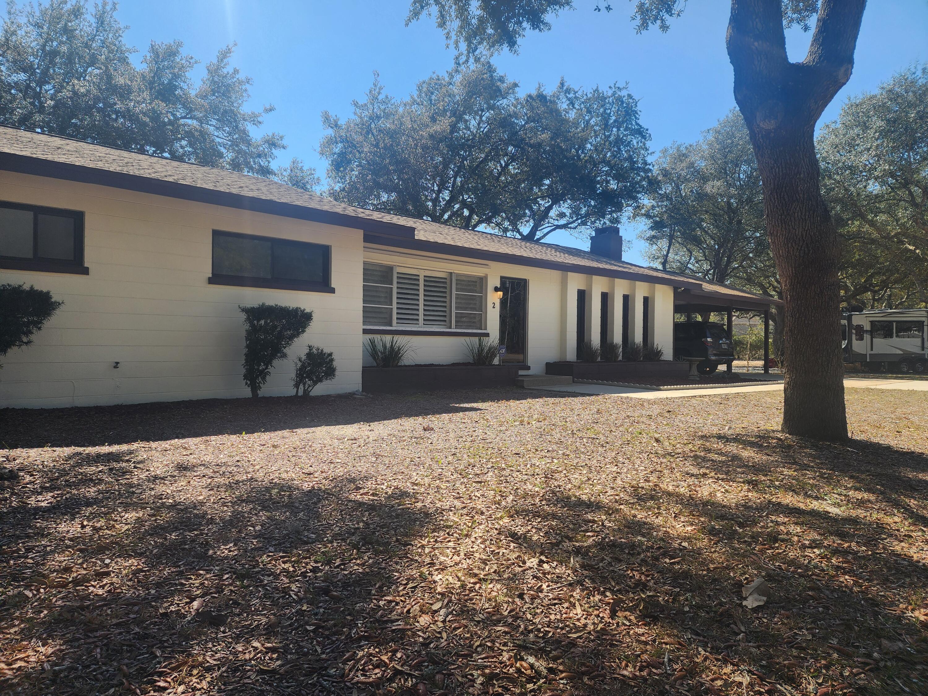 Come see this gorgeous, completely renovated home in Poquito Bayou! Located in the Woodland Shores neighborhood, this corner lot home features several updates including a new roof (2023) as well as new electrical & plumbing. Enjoy the outdoors & entertain guests from the screened porch or cook amazing food on the brick grill on the open patio. Inside, the home showcases vaulted ceilings, a spacious family room accented by a gas fireplace, LVP & terrazzo flooring & remodeled bathrooms. The renovated kitchen includes stainless steel appliances, granite countertops, a breakfast bar, & a small serving window to the screened porch. The property is steps away from public water access & is within a mile of the Poquito Boat Ramp, within 4 miles of Eglin AFB, & within 9 miles of Okaloosa Island.