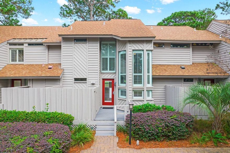 Every day feels like a vacation at this well-maintained townhome in Sandestin Golf and Beach Resort. Located on The Links Golf Course, it has uninterrupted views of Choctawhatchee Bay beyond the lake and tree-lined fairway. Stone-paved parking at the front of the home includes a charging point for your golf cart with two spaces. There's even room to store bicycles and beach toys. Step onto the shady front porch area with Trex decking and head inside. LVP flooring flows naturally throughout the first floor, stairs, and landing on the second floor. A half bath with storage closet provides usable storage space. Shiplap walls and French doors feature in the tastefully furnished dining and sitting area, providing alluring views and access to the outdoor space. Look forward to relaxing and