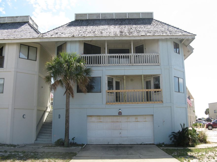 REO. Views of the Destin Harbor and East Pass. Close to the beach. Three level townhouse with two car garage on first level, two bedrooms/two baths on second level and the top level is the living/dining area, half bath and kitchen. Selling as-is. Needs work. Room dimensions are approximate.