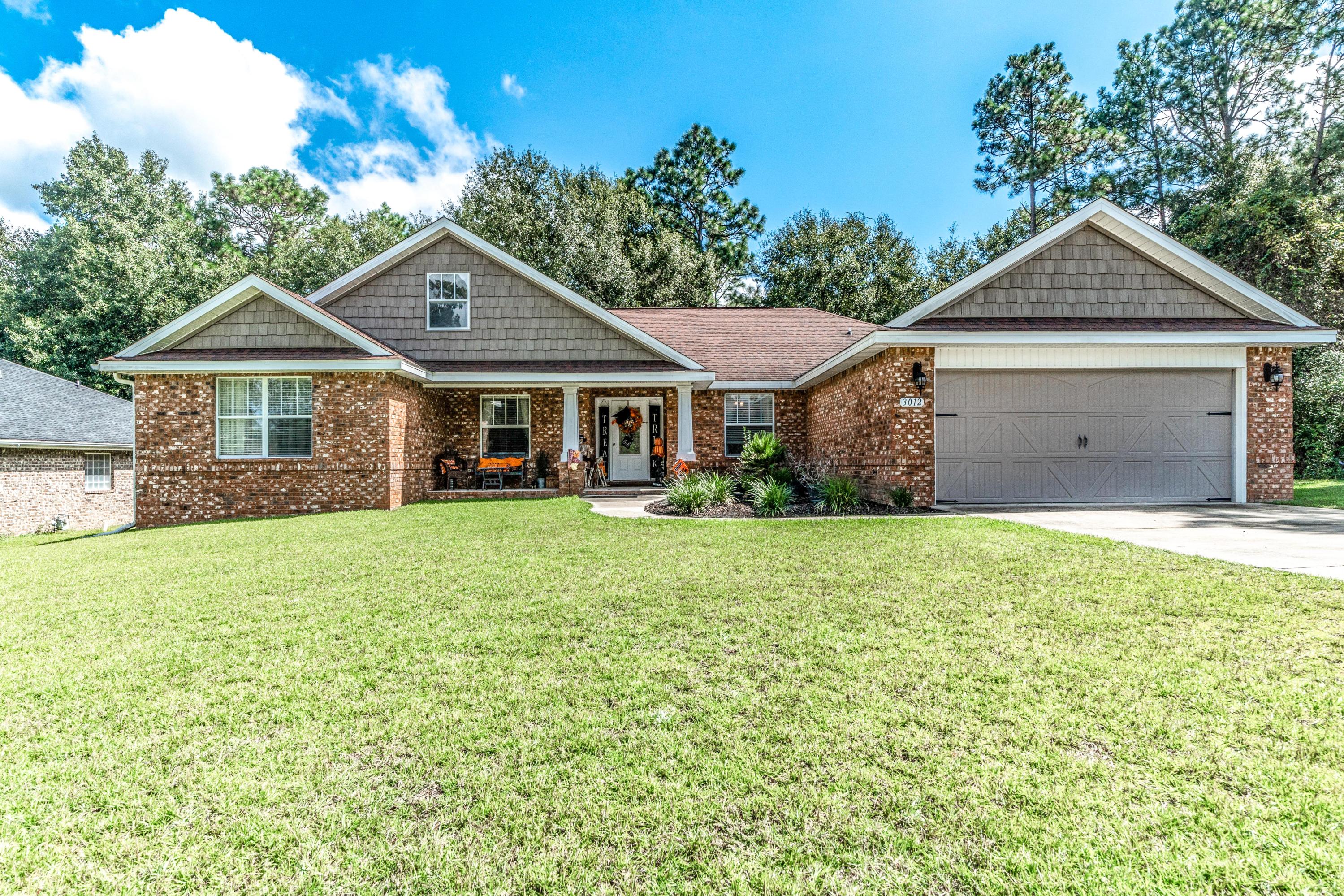 As you drive up to this immaculate brick home you will notice the stunning barn door features on the garage and shake tile accents. Enter the front door to be greeted by wood flooring throughout the main living room and dining room. The living room boasts vaulted ceilings, bull nose corners, decorative ledges, built in bookshelves, and more! The open floor plan allows for a spacious kitchen accented with diagonal tile floors, granite counters, stainless steel appliances to include a french door fridge, pantry, breakfast bar, island, work space and eat in area. The list of features of this stunning home go on and on! There are 4 true bedrooms, a formal dining room, and separate office. The master bedroom features a split floor plan and spacious master bathroom. The backyard is a dream.