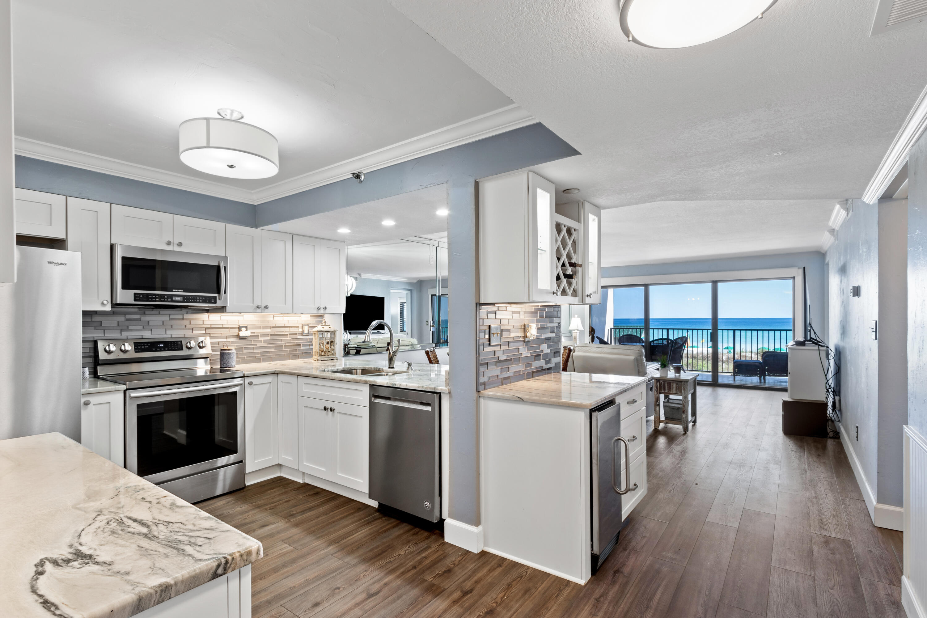 Highly Sought after Gulf Front unit at Emerald Towers.Gorgeous 2nd floor unit with panoramic views of the stunning gulf water and the white sandy beach. Totally remodeled unit. The kitchen contains all stainless steel appliances , quartz countertops, beautiful tile backsplash, custom lighted cabinetry, wine cooler and bar with ice maker. Laundry closet with stacked LG washer & Dryer. The primary bedroom features a king bed, plantation shutters and access to the balcony. The primary bath features a built in linen closet with lots of storage and a walk-in shower. The living area has remote power window shades.. This condo is turn key! Emerald Towers amenities include a seasonally heated pool, tennis/pickleball courts and exercise room with sauna and steam shower. More. . .