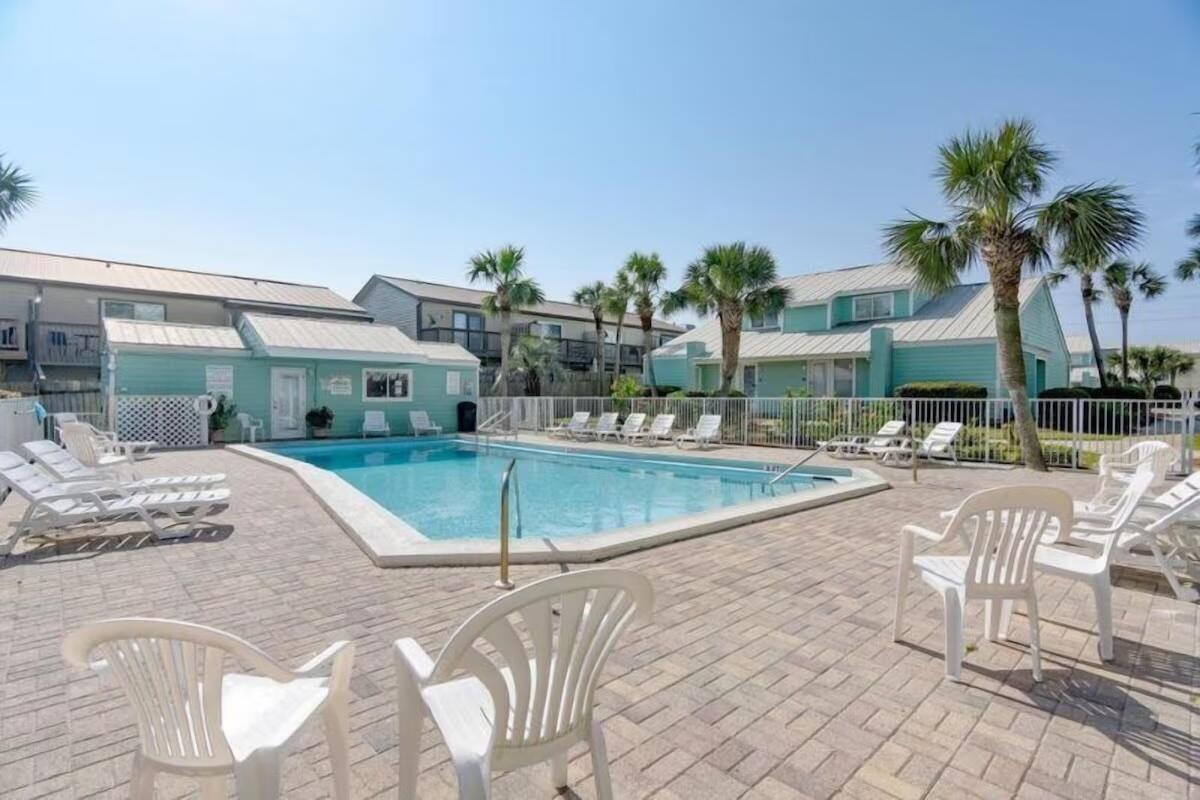This is the one you've been waiting for! Sea Cabins # 5C features deeded beach access, one of only a few units on stilts for peace of mind from weather, low HOA fees, and an owners closet for all your beach gear. Just across the street is gated access to 100 feet of private beach. There is one loft bedroom, a bunkroom and two full bathrooms. New metal roof in 2023, and new AC in 2020. Close to the beach, shopping, Silver Sands Outlets, and restaurants - with partial Gulf view and community pool, along with reserved parking for the unit in the shade. This unit truly has it all, and is one of the most affordable in Miramar Beach! Buyer to verify all info and dimensions.