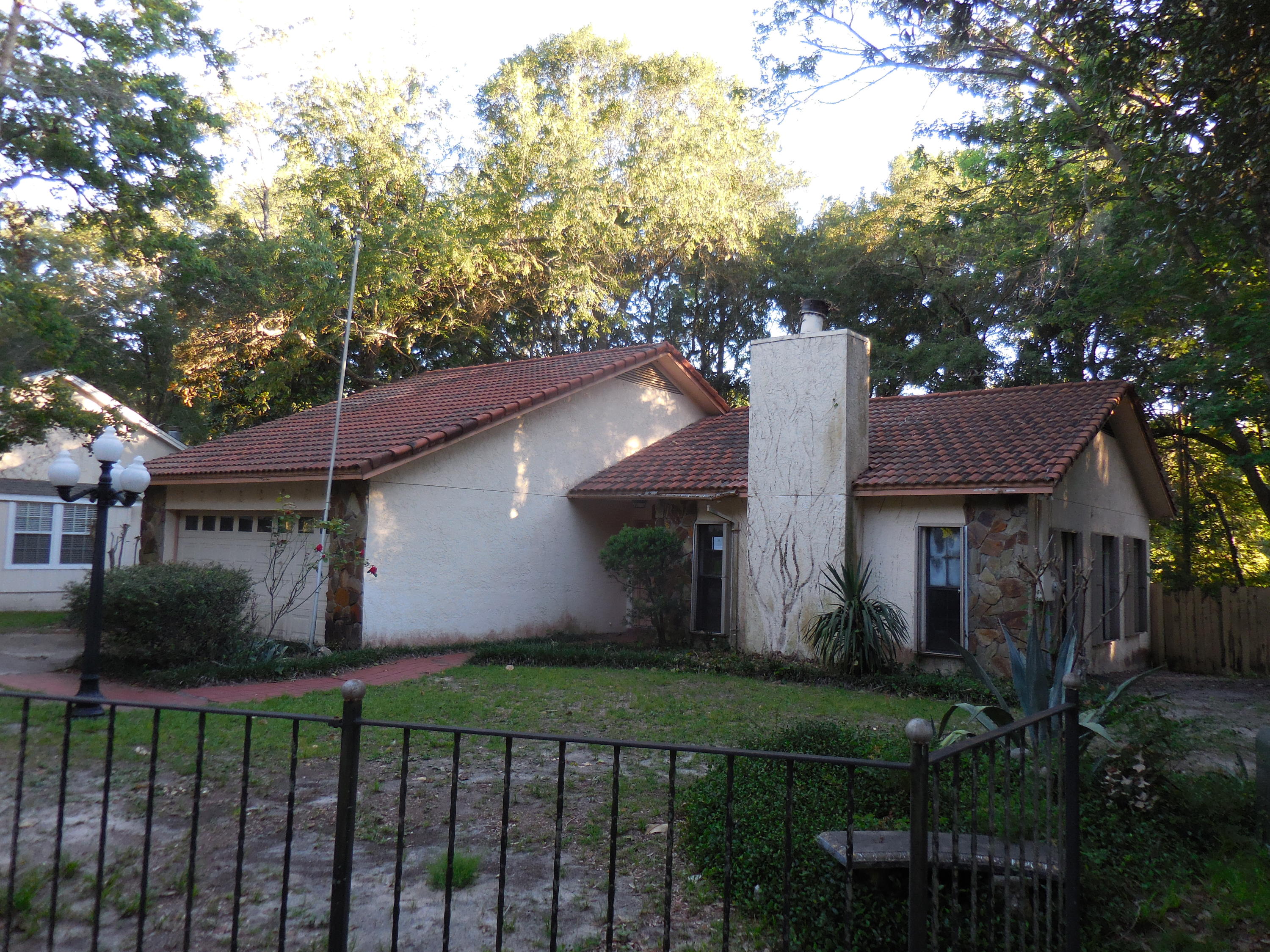 REO. Enjoy CREEK-FRONT living and much more! A beautiful flagstone fireplace will warm you in the wintertime and your own dock on the creek which leads out to the Bayou will refresh you in the summertime! This house features a tile roof and stucco exterior. A screened patio and open porch are perfect for BBQs. The living room with its vaulted ceiling and fireplace leads to the dining room and on to the kitchen with a breakfast ''L''. 3 bedrooms and 2 baths are perfect for any family. The 2-car and laundry room and outside workshop with electricity round out this great property!