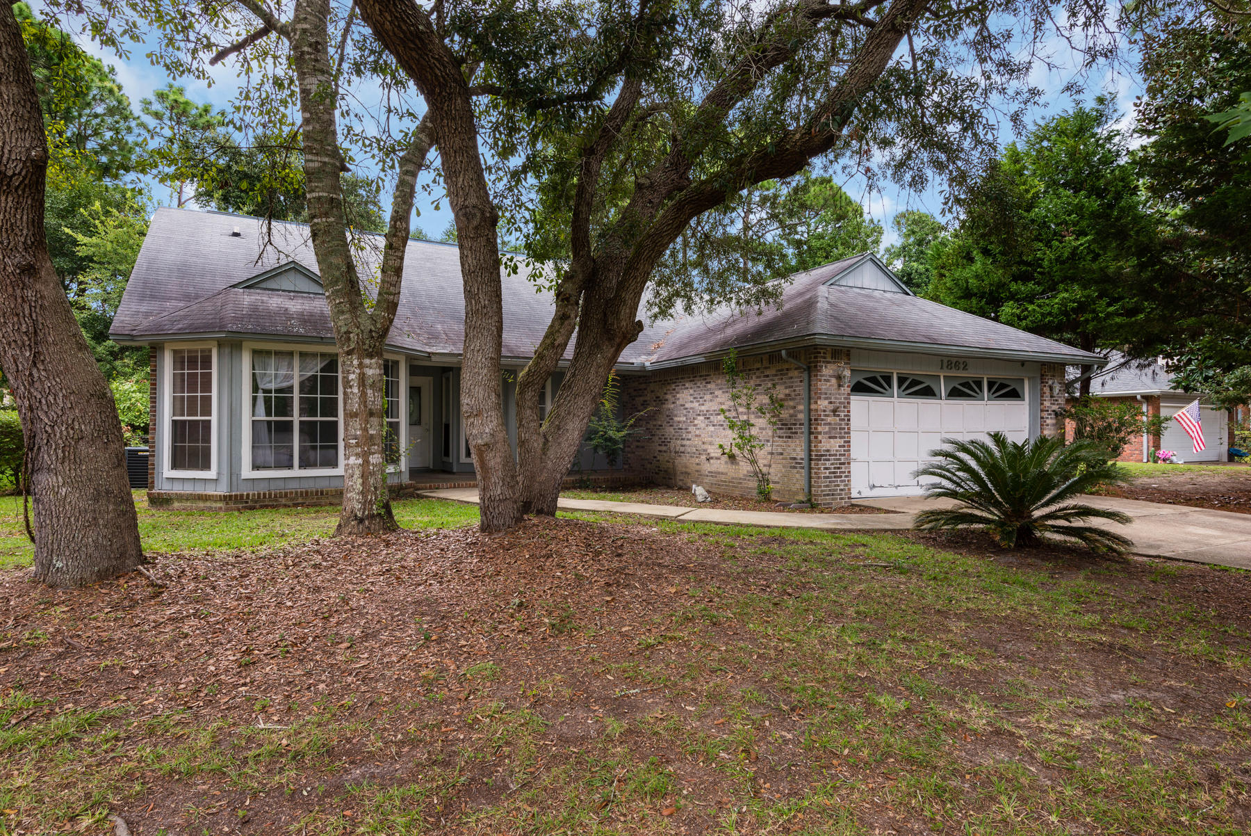 !!!Great deal for the handy buyer who doesn't mind a little sweat equity!!! Home had new AC unit replaced in 2007, SELLER TO REPLACE ROOF and GARAGE DOOR WITH ACCEPTED OFFER. Enjoy a large wooded fenced lot with screened-in porch, Home also features tall vaulted ceilings in living room and master bedroom and tiled floors through-out. Design includes split bedroom plan, large kitchen w/huge pantry closet and large breakfast nook. There's a separate formal dining room with chair rails and a bay window. The front bedroom also boasts a bay window. The living room features a floor to ceiling wood burning fireplace that adds warmth to this charming home. Full length glass doors lead from living room to the screened porch and master bedroom to the enchanting wooded backyard. MUST SEE!!!