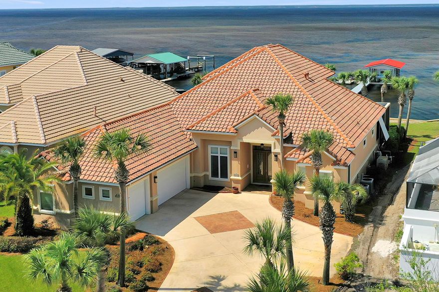 *BEST VALUE FOR A BAYFRONT HOME IN MIRAMAR BEACH* WHOLE HOUSE GENERATOR, HURRICANE SHUTTERS, RID O  RUST SYSTEM, NEW DOCK FALL 2020. THIS 2 STORY FLOOR PLAN  FEATURES MAIN LIVING ON 1ST FLOOR INCLUSIVE OF FORMAL + CASUAL SPACES, MASTER SUITE, GUEST BEDROOM AND BATH LAUNDRY, FULL POOL BATH AND OFFICE OVERLOOKING BAY. 2ND FLOOR IS CURRENTLY SITUATED AS 2 GUEST BEDROOMS AND BATH + EFFICIENCY KITCHEN. INTERIOR FOCUSES ON GORGEOUS BAY VIEWS THROUGH OPEN AND FLOWING FLOORPLAN. IMPECCABLE APPOINTMENTS INCLUDE PORCELAIN TILE, CROWN MOLDING, 10-14 FOOT CEILINGS,TRANSOM WINDOWS, CALIFORNIA CLOSETS IN MASTER SUITE, ANDERSON WINDOWS AND SLIDING GLASS DOORS, SECURITY/SURROUND SOUND, BUILT-IN PEST CONTROL (PEST GARD) GENERAC GENERATOR (WITH WARRANTY),