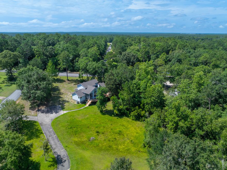Welcome to a truly special property that has been the backdrop for a life filled with love, laughter, and generational memories, and built with heart and meticulous craftsmanship. Nestled on 4.66 partially wooded acres, this custom-built, well-maintained one-owner home is ready for its next chapter, featuring freshly painted walls, ceilings, and new carpet in the living room and primary suite. The main floor offers a large primary suite with an attached office/reading nook or nursery. The en-suite bath includes dual vanities, a walk-in shower with dual heads and bench seating, a garden tub, and a walk-in closet. Soaring two-story vaulted ceilings and a gas fireplace highlight the living room, illuminated by a nearly floor-to-ceiling window. An open layout connects the living room, dining area, family room, and kitchen, which boasts a walk-in pantry and a sink with a plant shelf overlooking the backyard. Upstairs, you'll find two spacious bedrooms, a full bath, and a landing with views of the living room below. The laundry/utility room leads to a screened patio and a massive two-level back deckperfect for entertaining or peaceful mornings. A standout feature is the fully powered, climate-controlled 3-bay detached workshop with a two-car and single-car garage door, water, sink, bathroom, and plumbing for a shower. Perfect for woodworking, car restoration, RV storage, or serious hobbies, it's complemented by an adjacent tall carport and two additional storage buildings. The expansive 4.66 acres offer ample cleared space for a garden, greenhouse, playground, or even a solar farm, while maintaining wooded privacy and abundant wildlife. Located on a quiet rural road yet minutes from shopping, this isn't just a  houseit's a forever home ready to welcome families, craftsmen, or both.
