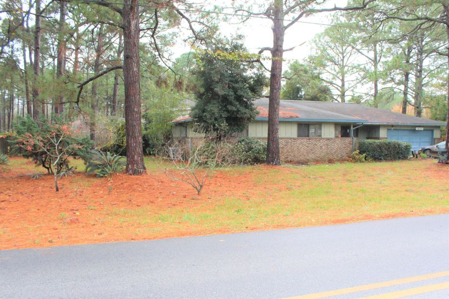 Multiple offers--submit highest and best by 2 pm Sunday, Jan 24th. This 3 bedroom 2 bath has a fantastic location on a double lot with more than half an acre!  Attractive brick exterior with board and batten accents, double car garage and huge laundry/storage area.  Older home with some recent updates--new water heater 2017; AC replaced 5 years ago; recent vinyl plank flooring in some areas; new front door.  Access the covered back porch from the kitchen, living room and master bedroom. There is a beautiful wood burning fireplace in the living room and a cool bar pass-thru to the kitchen.  This home has plenty of storage and closet space, including a walk-in kitchen pantry.  Large master suite with bay window and open bathroom vanity area with sky lights for natural ligh