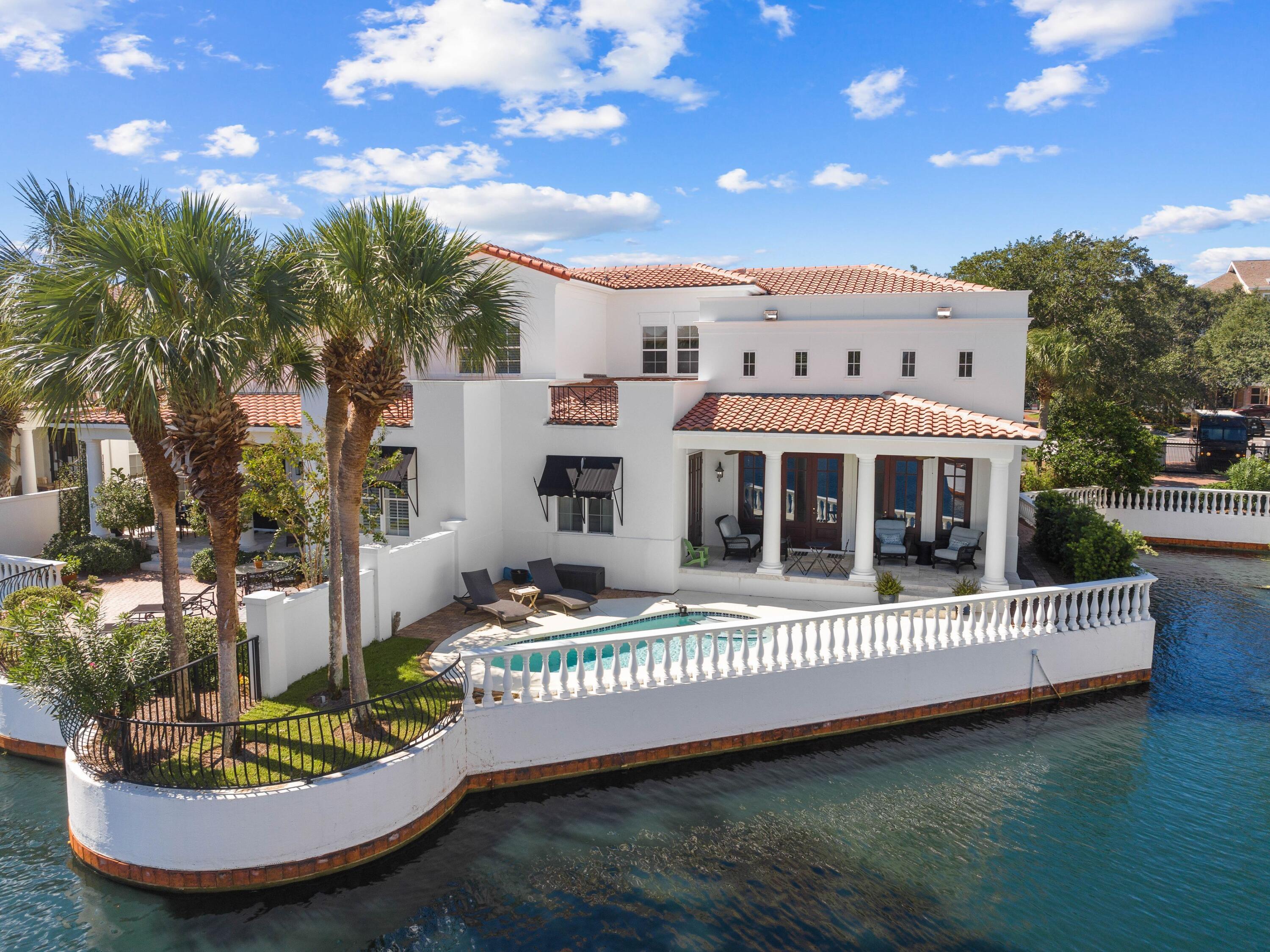 This premier two-story villa in Fountains at Sandestin offers incredible lake and golf views and a home to covet. A sweeping driveway approaches the two-car garage and entrance. Travertine flooring and soaring 18-foot ceilings with clerestory windows create a breathtaking living space with a row of doors framing lake and fairway views. Entertainers will love the separate dining area that sets the scene for memorable evenings spent with family and friends. The kitchen is a chef's delight with endless quartz countertops and stainless appliances combining practicality with upscale refinement. There's a pantry, full-sized laundry room and understairs storage keeping everything neatly out of sight.