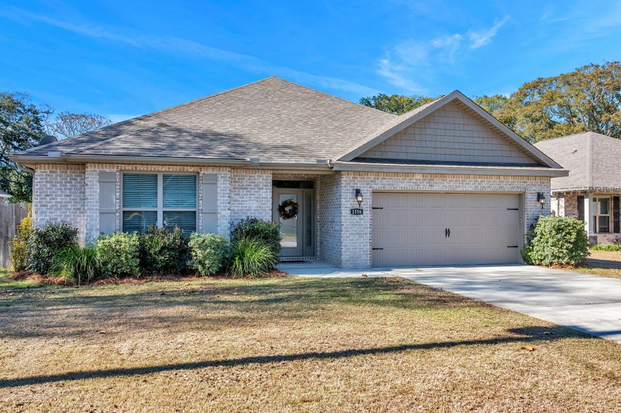 Experience timeless charm in this beautiful all-brick home built in 2018,  featuring four bedrooms and two baths. Nestled on a spacious lot, this residence blends modern comfort with classic elegance. It has an open floor plan with lovely plank tile flooring throughout and carpet in the bedrooms.  Living room is spacious and boasts an impressive tray ceiling, recessed lighting and crown molding. Kitchen is open to the Living room and has granite countertops, tile backsplash, stainless steel appliances, a breakfast bar and recessed lighting.  Wonderful split bedroom floor plan with the 4th bedroom located toward the front of the home. This room could also be used as an office or work out room.  The two additional bedrooms are off the hallway with the bathroom in between.  Master bedroom is